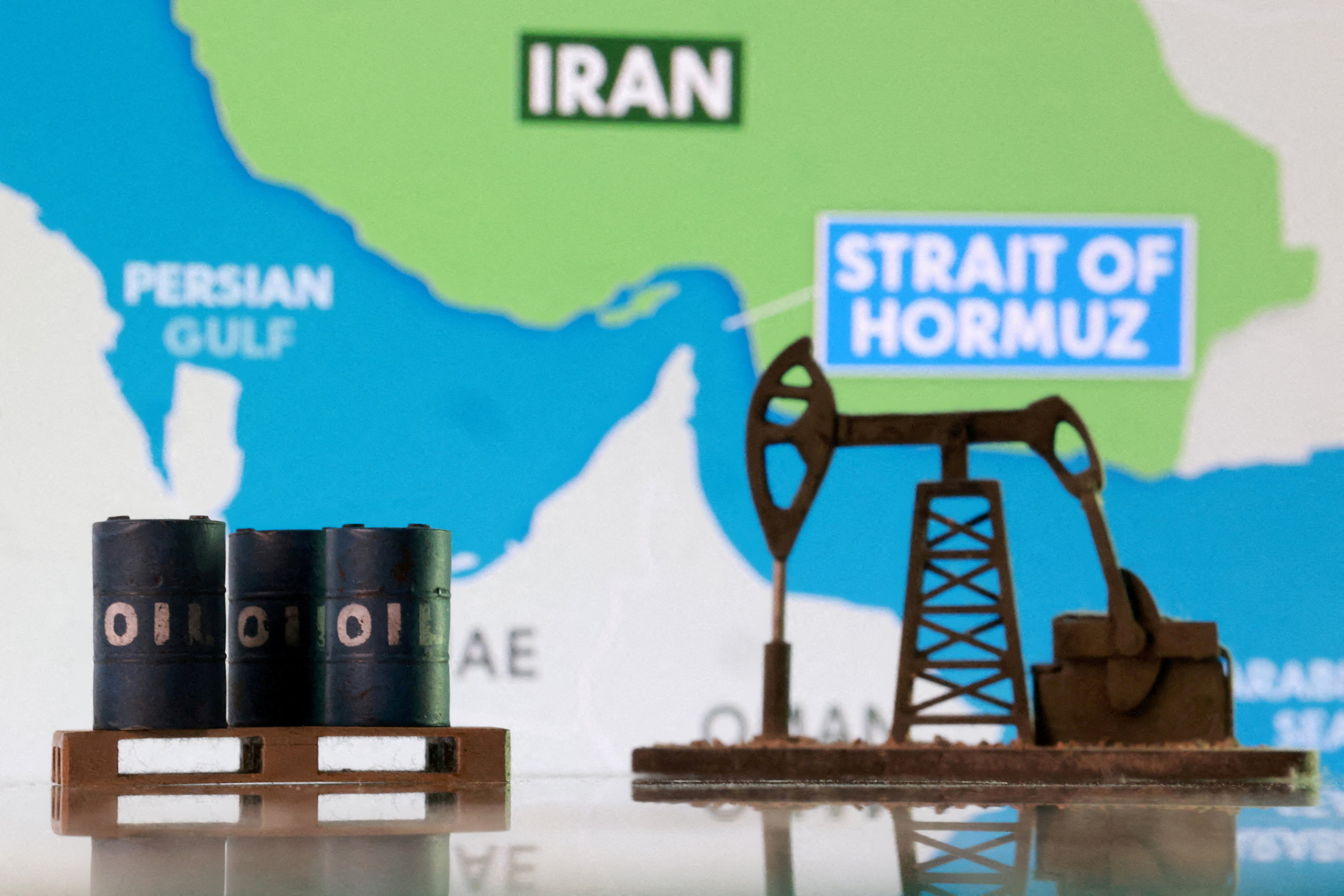 Illustration shows 3D printed oil pipeline and map showing the Strait of Hormuz and Iran