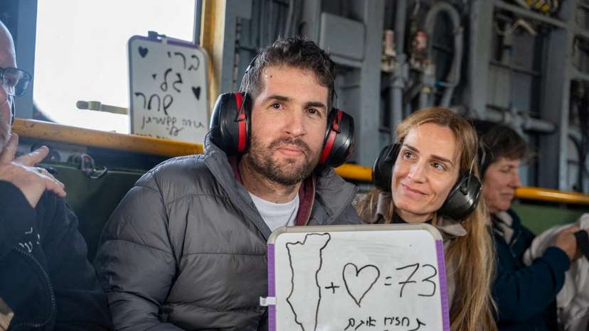 Released hostage, Sagui Dekel-Chen, who was seized during the deadly attack by Hamas, sits next to his wife as he flies to central Israel