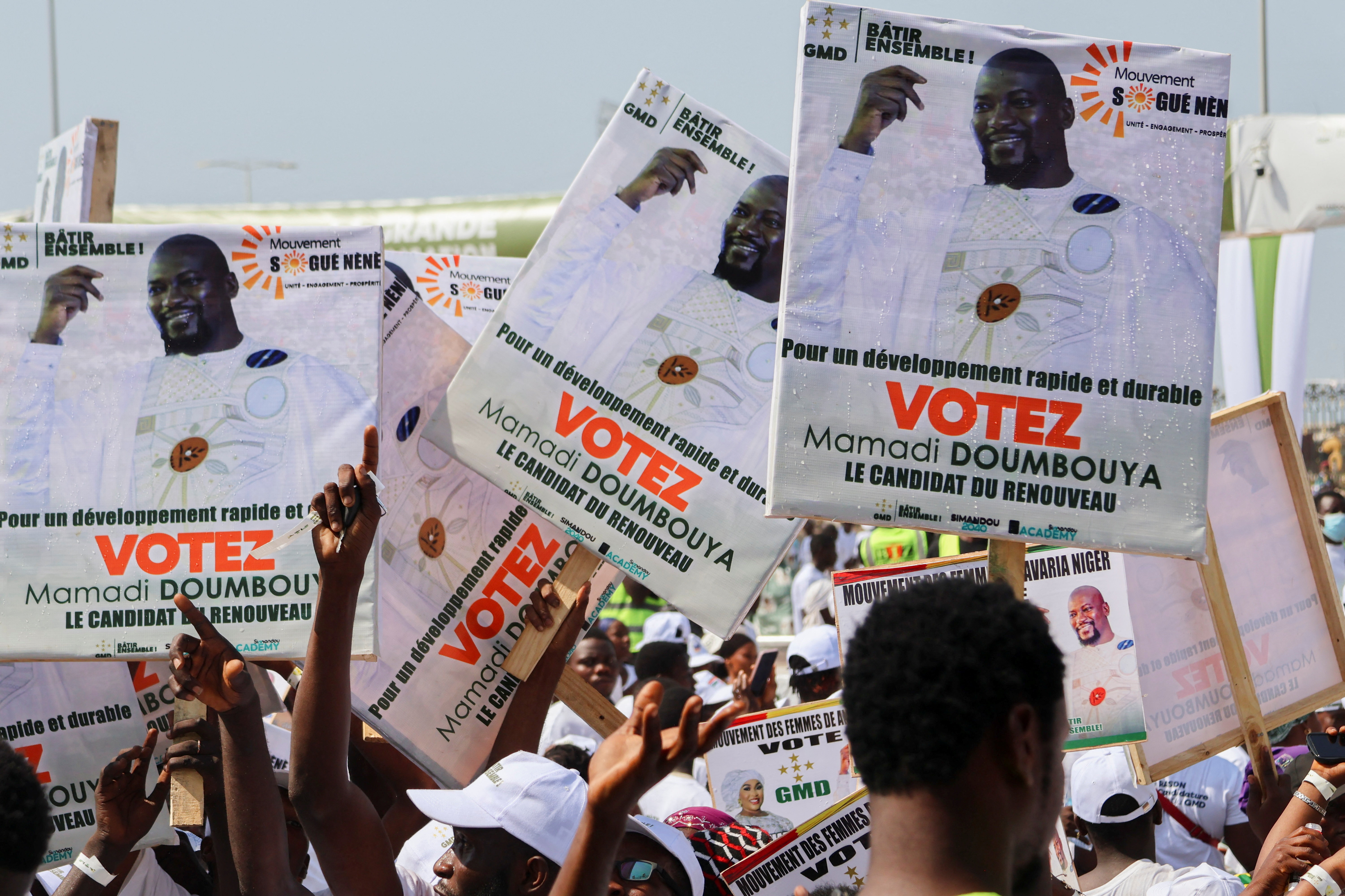 Supporters of Guinean leader and presidential candidate Mamadi Doumbouya take part in his final campaign rally in Conakry