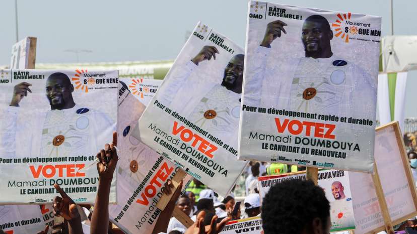 Supporters of Guinean leader and presidential candidate Mamadi Doumbouya take part in his final campaign rally in Conakry