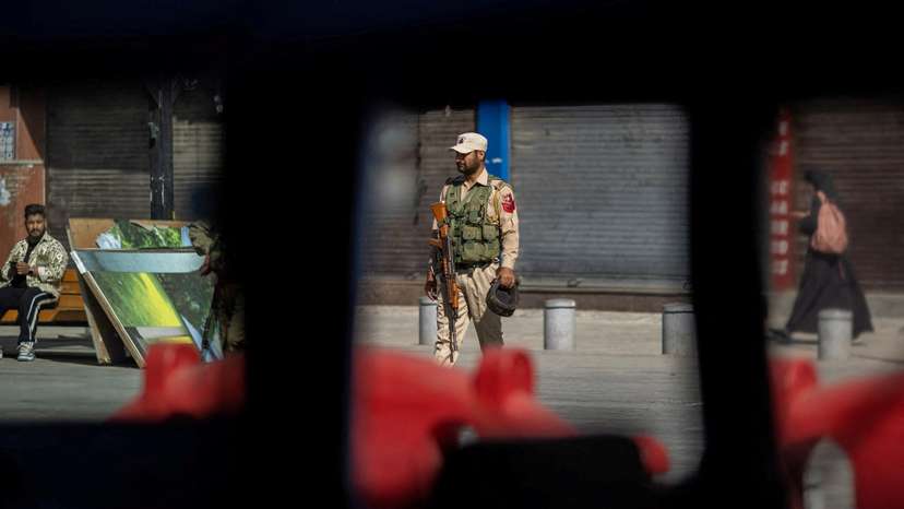FILE PHOTO: An Indian security force personnel stands guard on a street in Srinagar