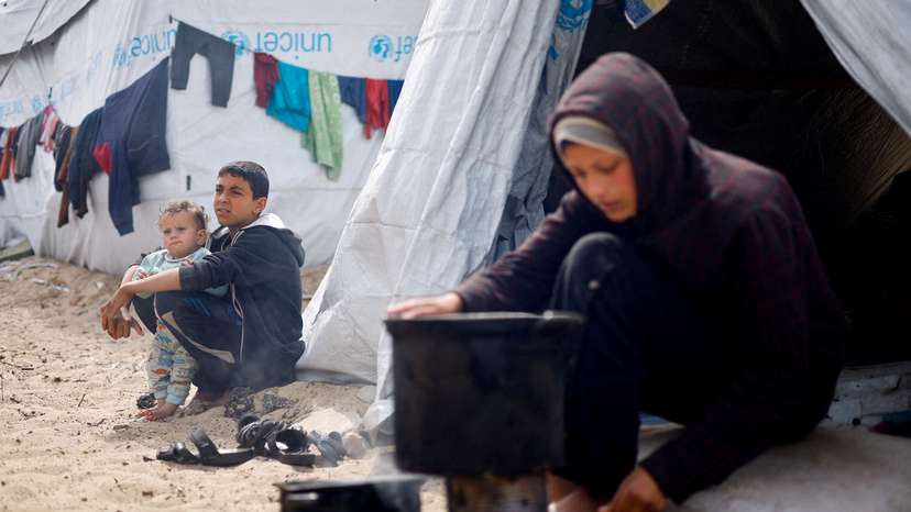 Displaced Palestinians, who fled their houses due to Israeli strikes, shelter at a tent camp, in Rafah