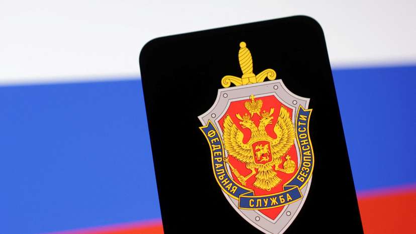 FILE PHOTO: Illustration shows FSB (Federal'naya Sluzhba Bezopasnosti) logo and Russian flag