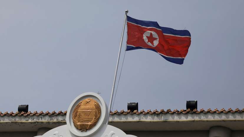 FILE PHOTO: The North Korean flag flutters at the North Korea consular office in Dandong