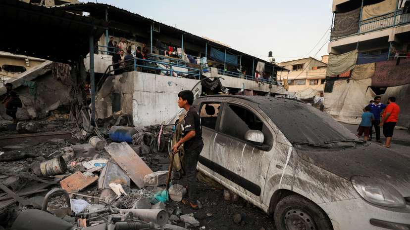 Palestinians gather at a UN school sheltering displaced people, following an Israeli strike, amid Israel-Hamas conflict, in Gaza City