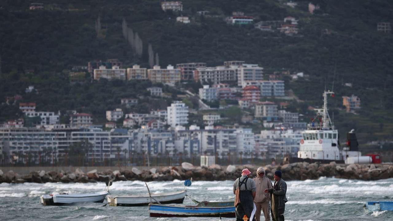 Fishermen stand by the sea in Vlora