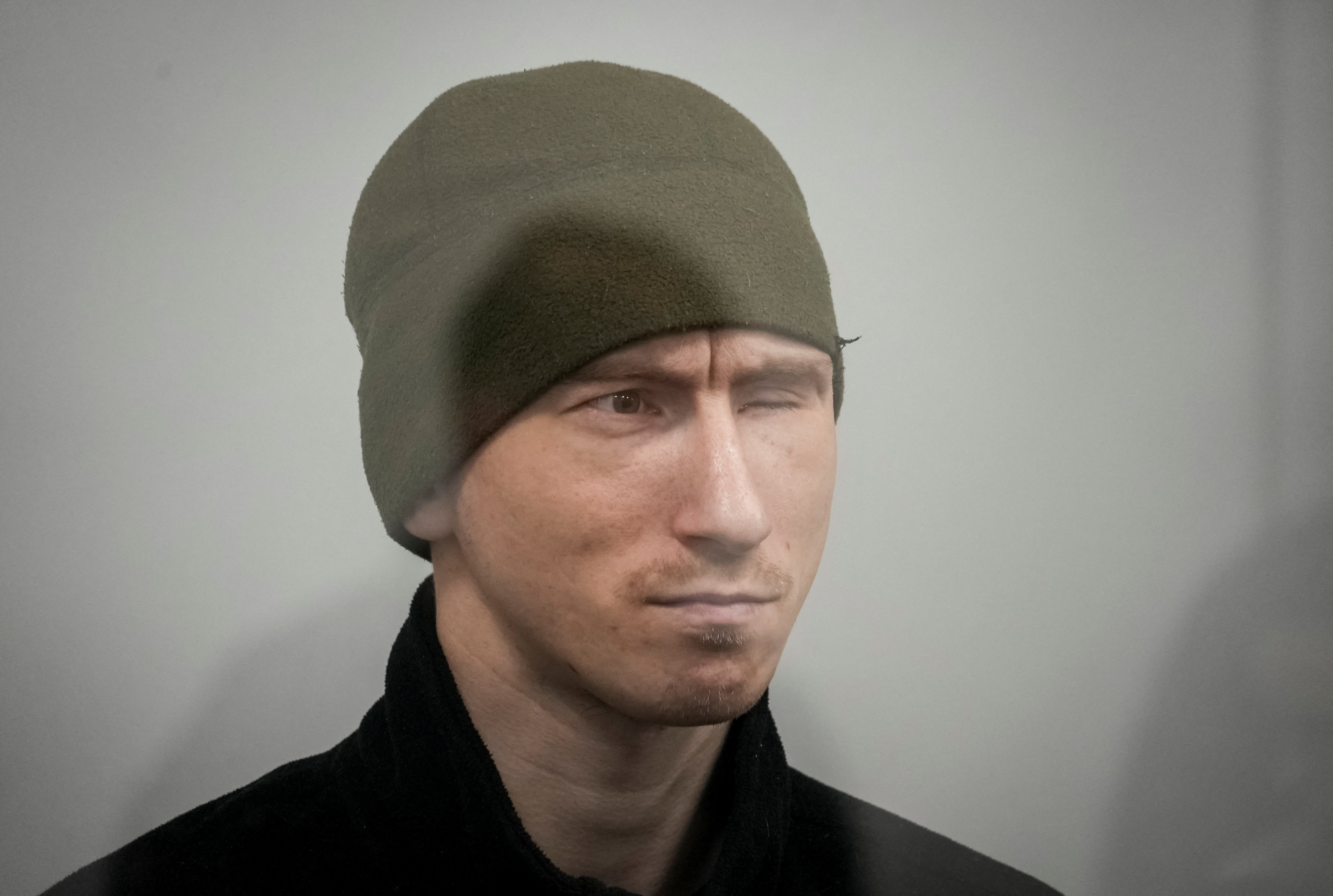 Russian soldier Kurashov, accused of committing a war crime, sits inside a cage during a court hearing expected to deliver a verdict in Zaporizhzhia