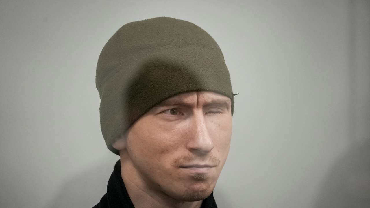 Russian soldier Kurashov, accused of committing a war crime, sits inside a cage during a court hearing expected to deliver a verdict in Zaporizhzhia