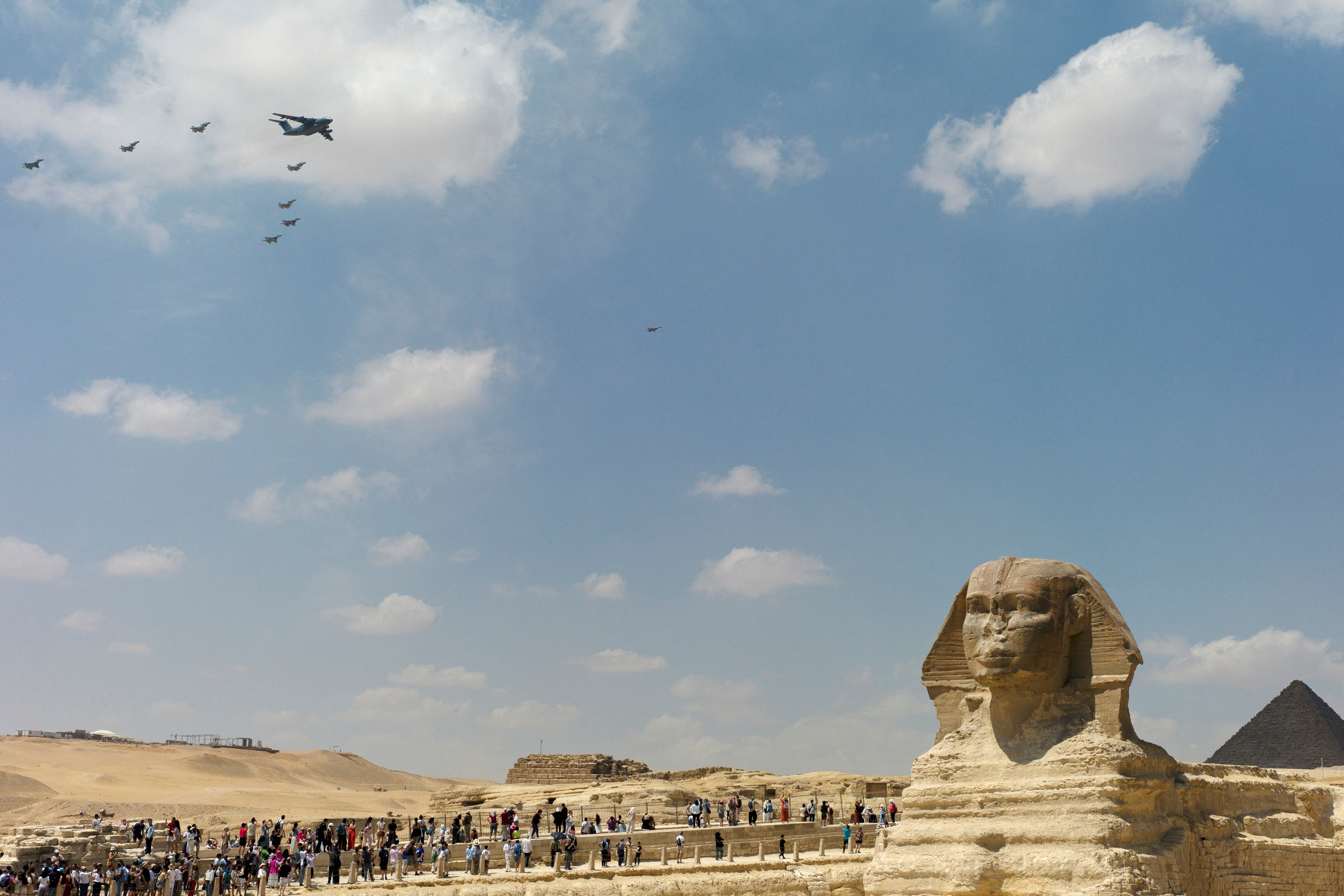 Military aircraft fly in formation at the Giza pyramid complex