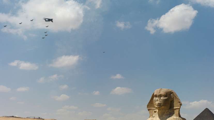 Military aircraft fly in formation at the Giza pyramid complex