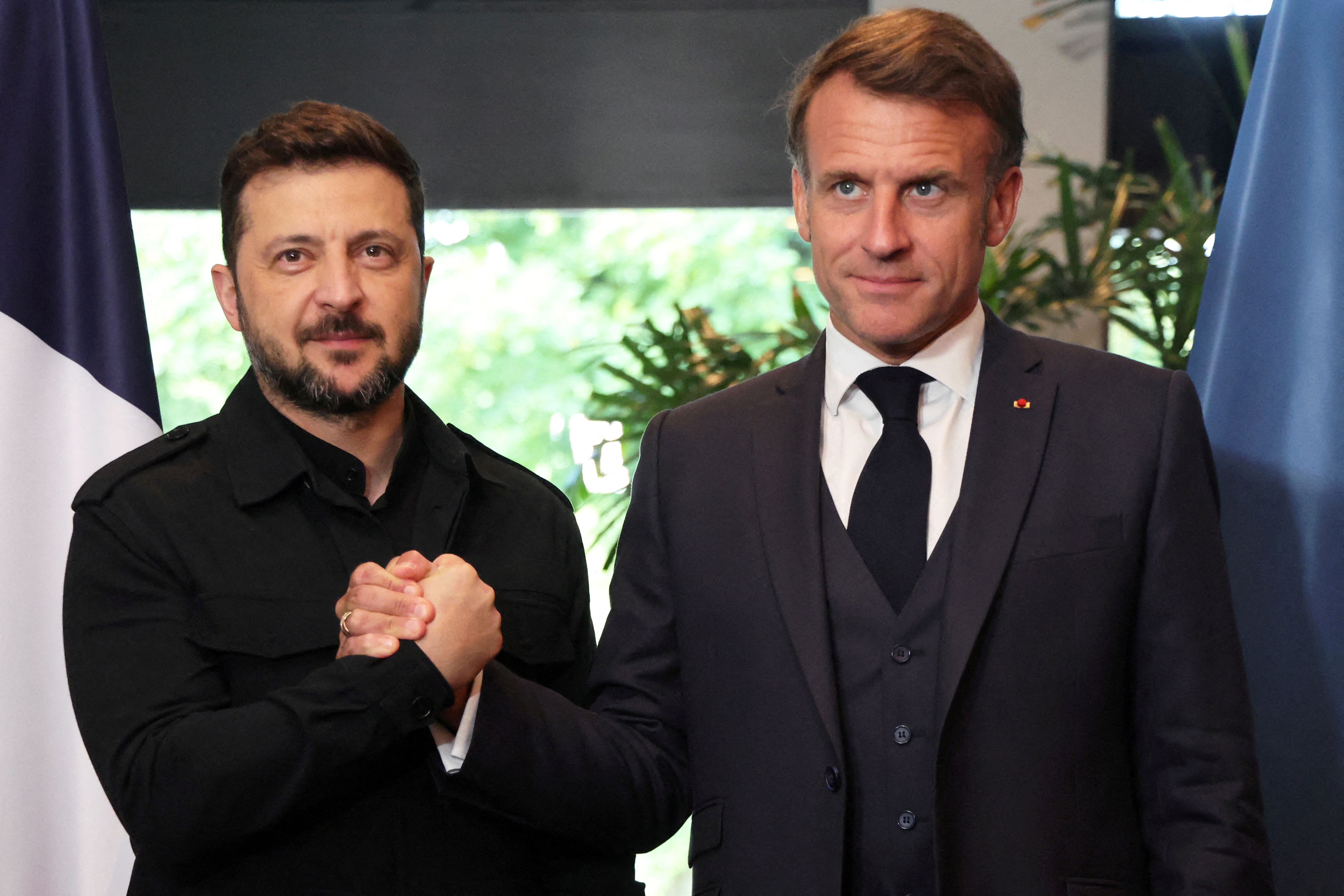 FILE PHOTO: France's President Emmanuel Macron and Ukraine's President Volodymyr Zelenskiy meet in The Hague