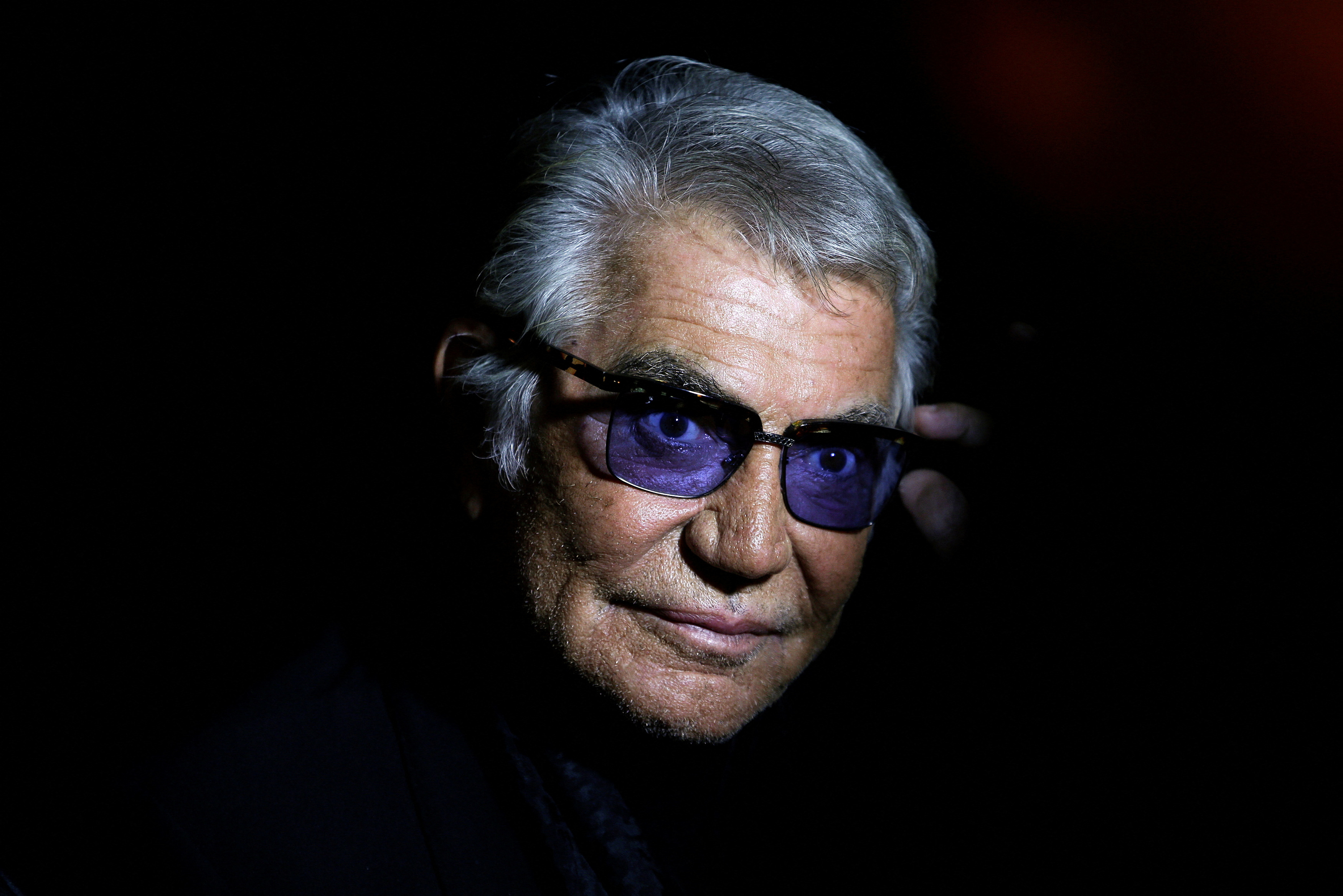 FILE PHOTO: Cavalli poses before the start of his Spring/Summer 2014 collection during Milan Fashion Week