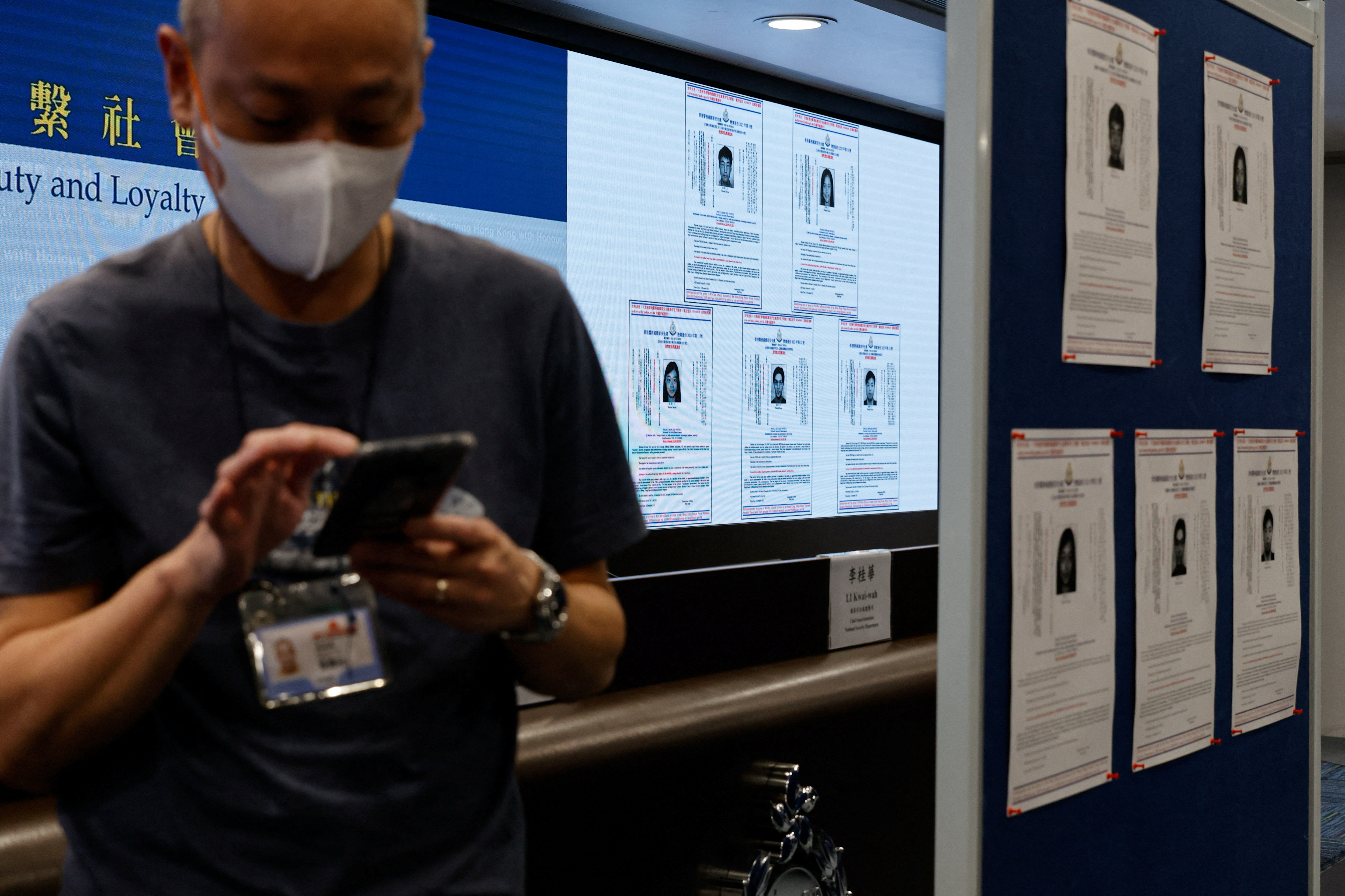 Images of five activists Simon Cheng, Frances Hui, Joey Siu, Johnny Fok, and Tony Choi are displayed during a press conference to issue arrest warrants in Hong Kong