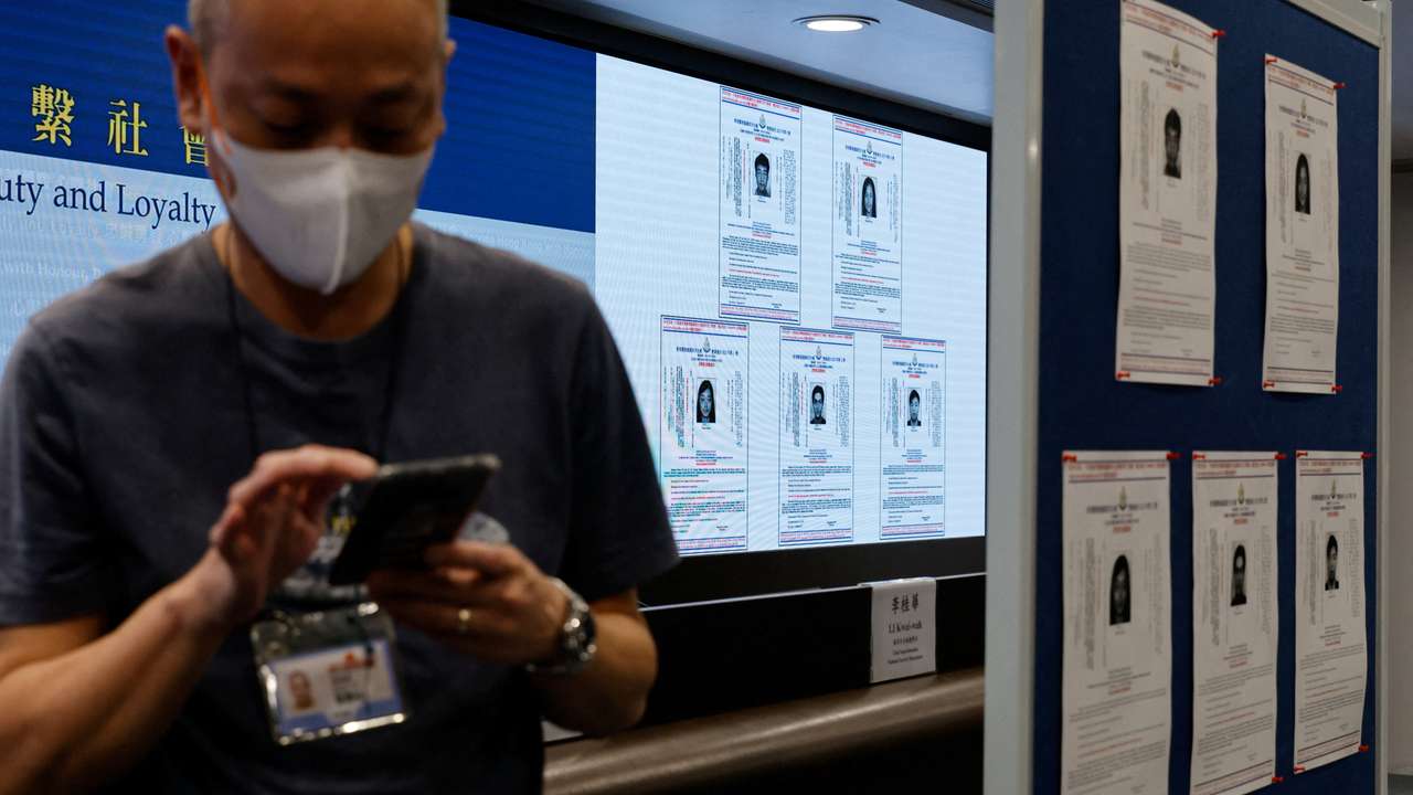 Images of five activists Simon Cheng, Frances Hui, Joey Siu, Johnny Fok, and Tony Choi are displayed during a press conference to issue arrest warrants in Hong Kong