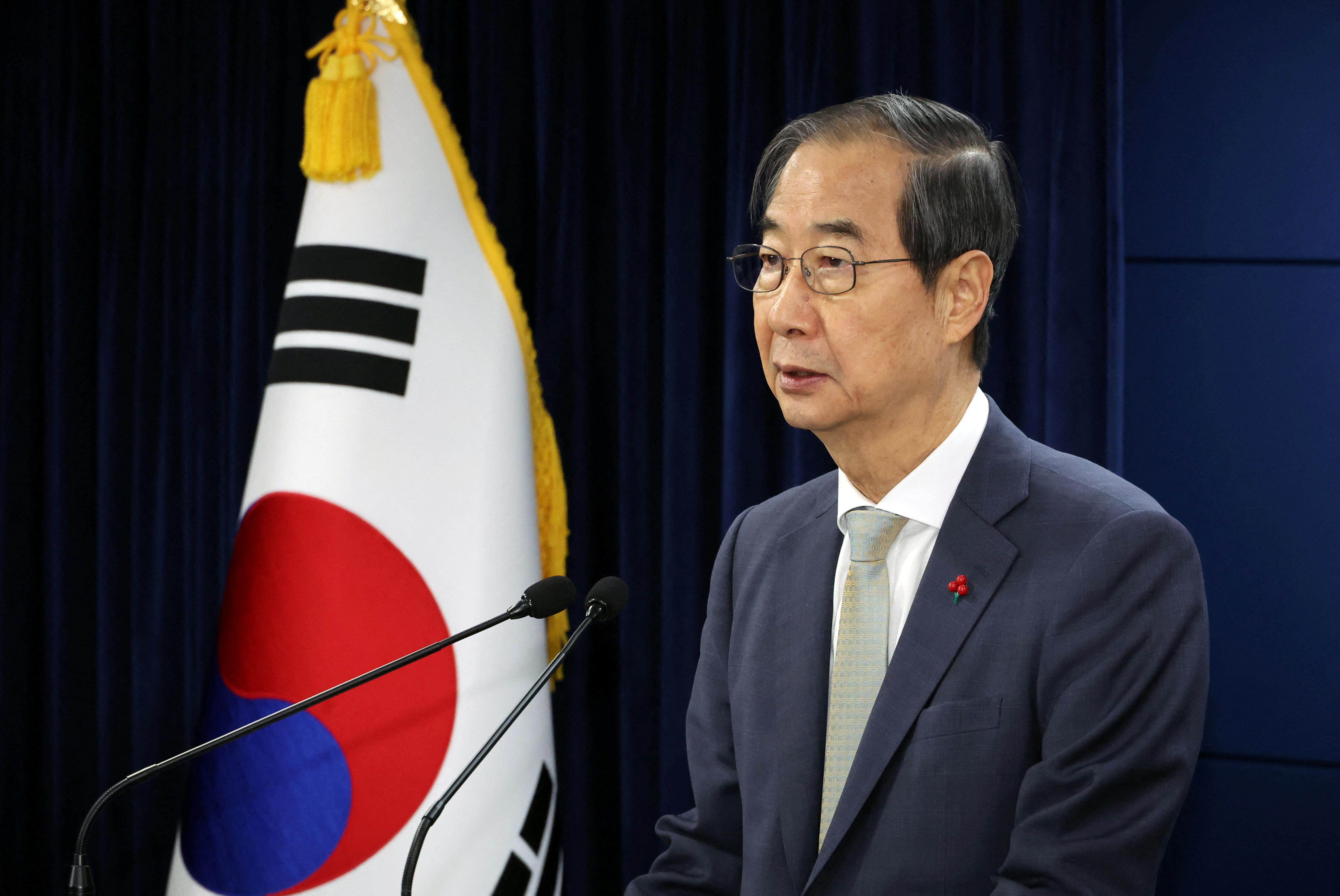 Acting South Korean President and Prime Minister Han Duck-soo delivers an address to the nation at the government complex in Seoul