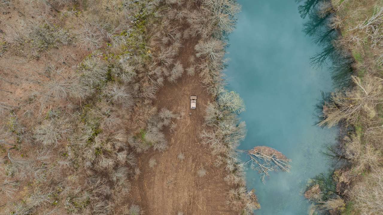 A drone view shows remote-controlled deminer vehicle working on a field near Gospic