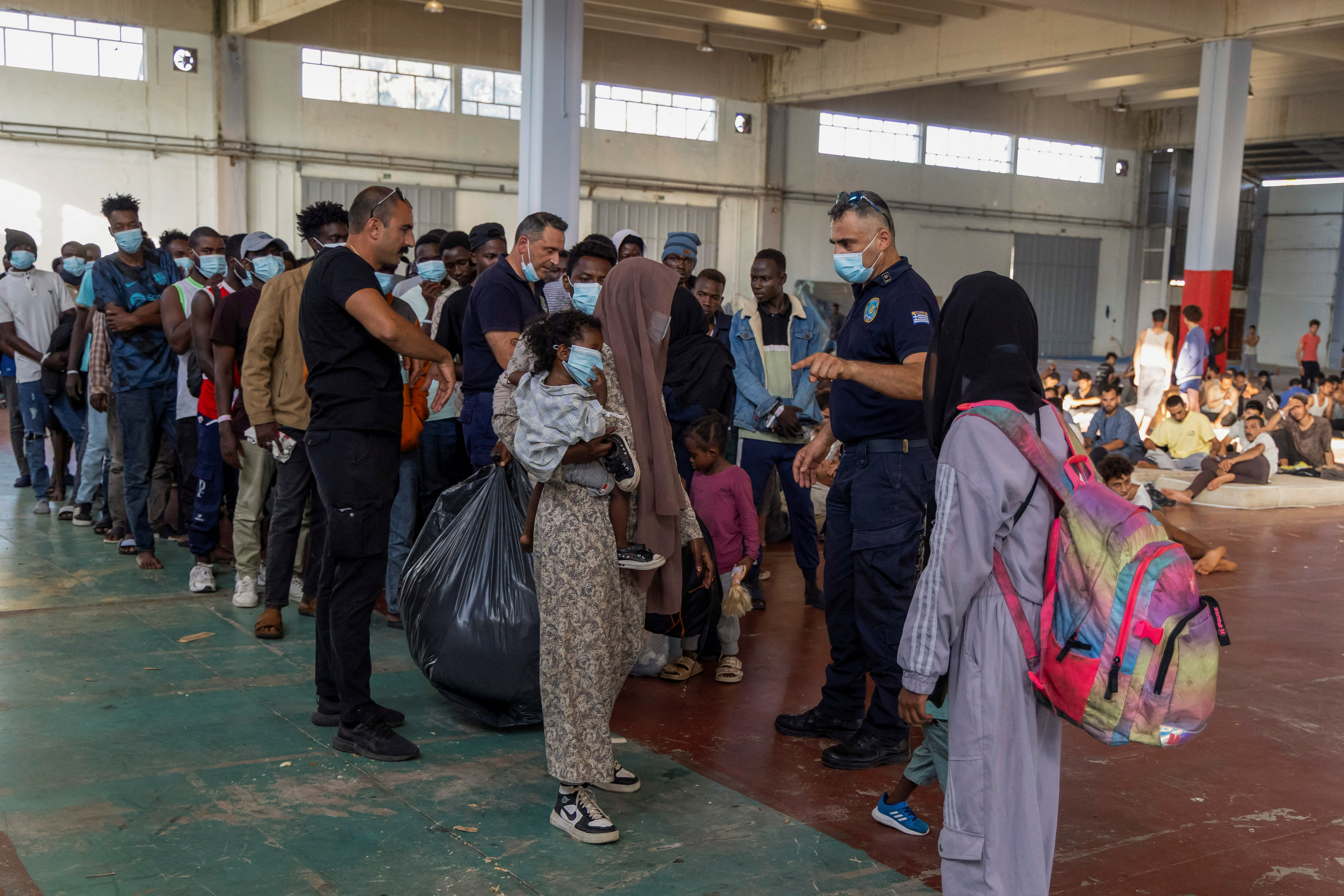 Newly-arrived migrants prepare to depart to mainland Greece, from Crete island