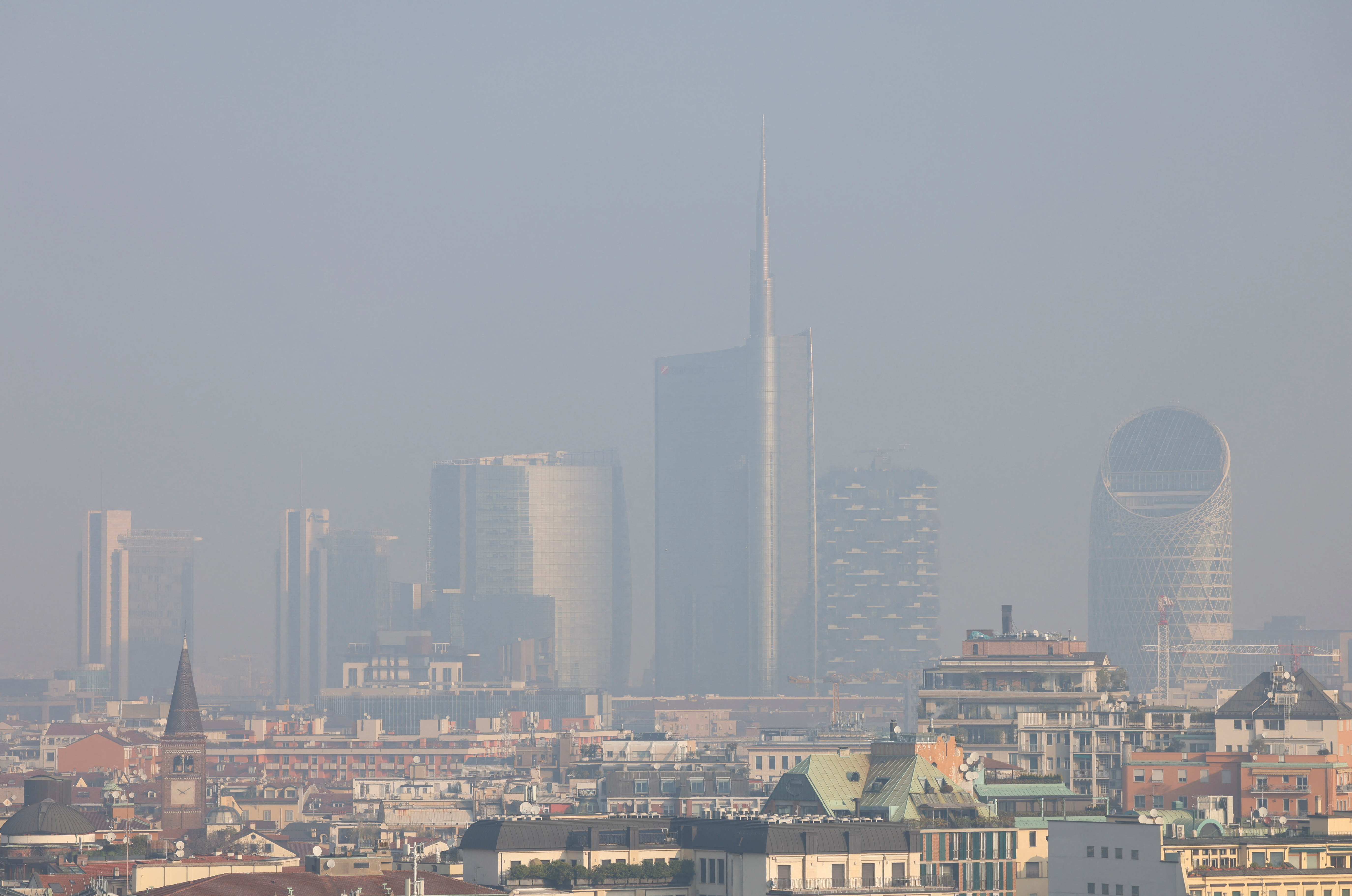 General view of high-rise buildings shrouded in smog in Milan