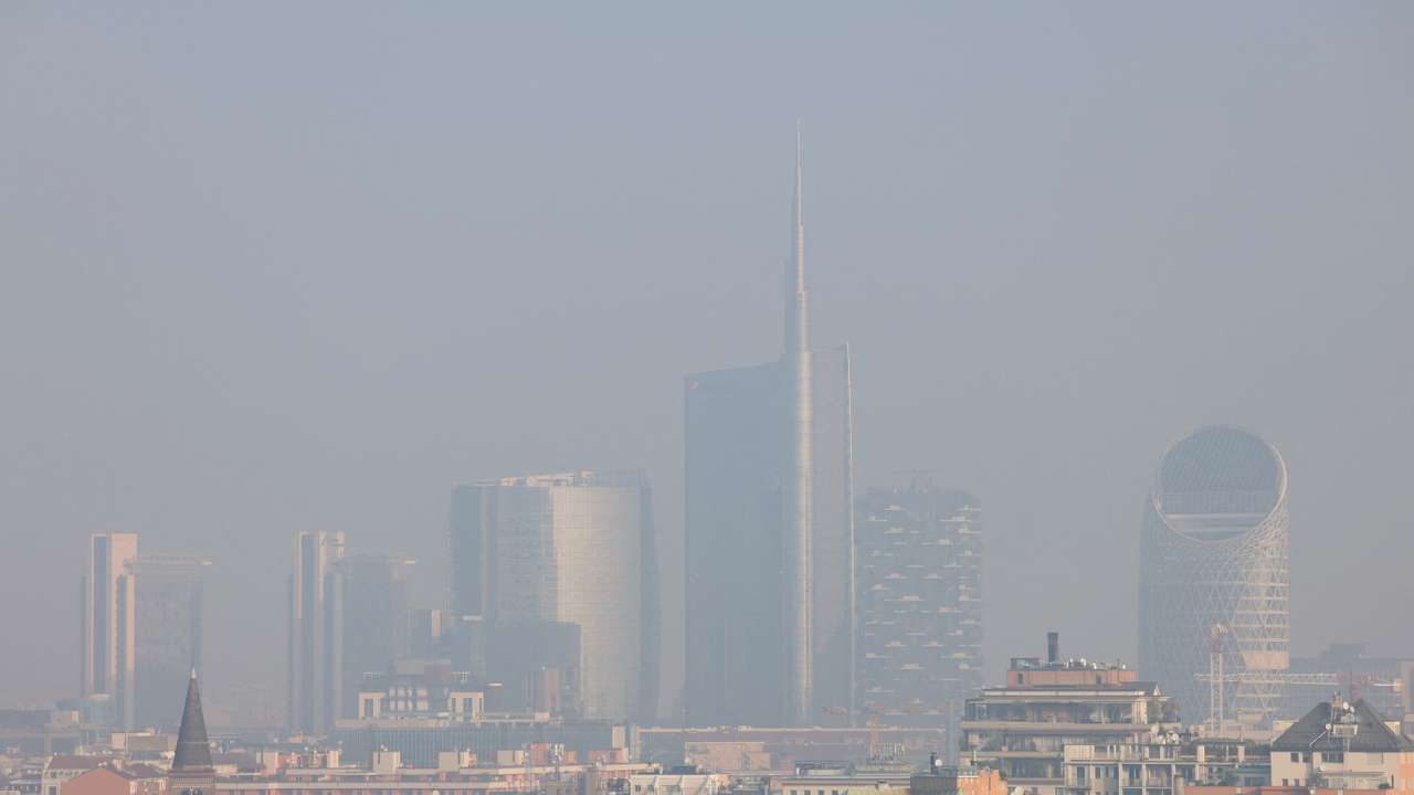 General view of high-rise buildings shrouded in smog in Milan