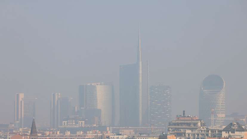 General view of high-rise buildings shrouded in smog in Milan
