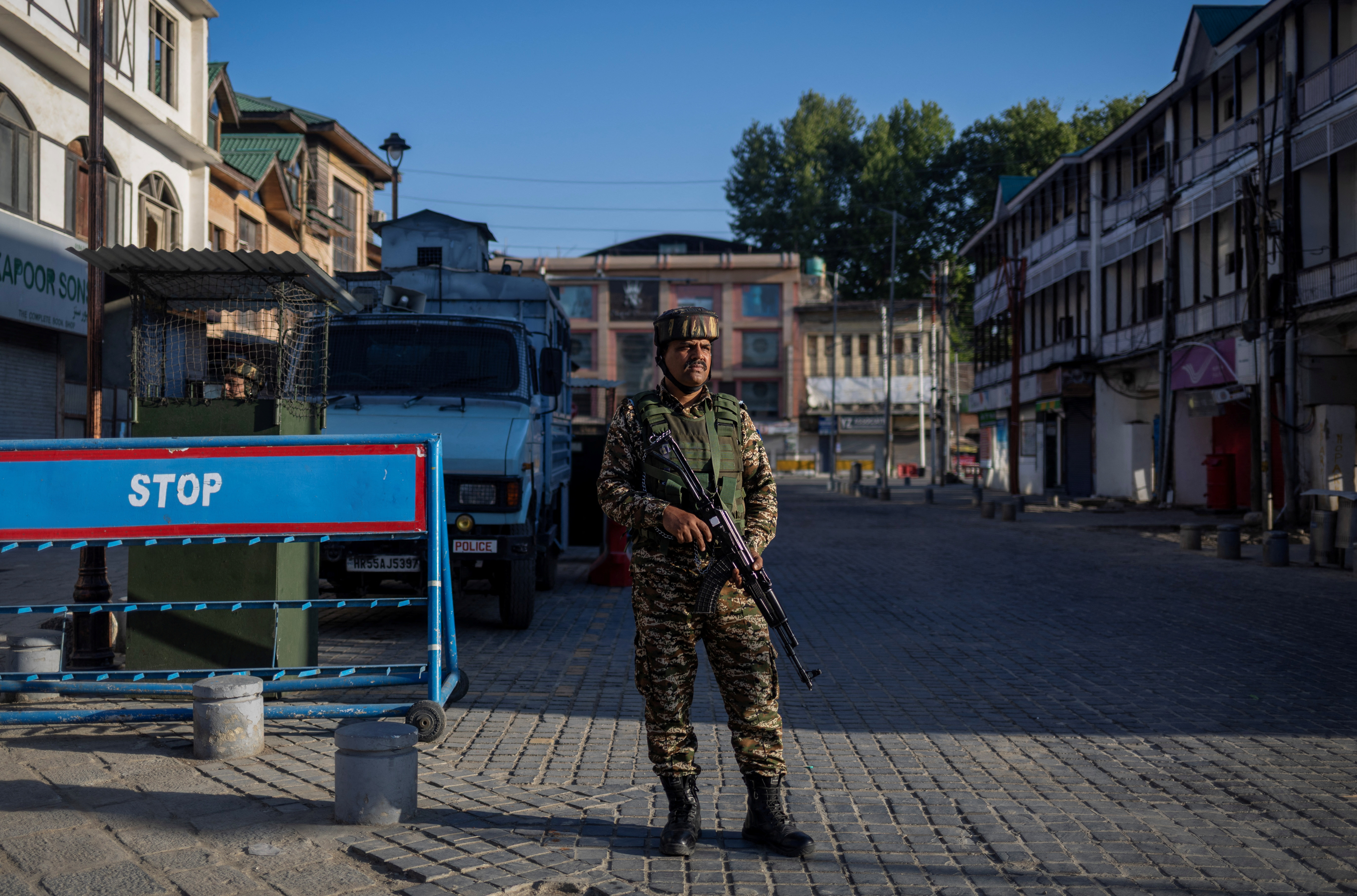 An Indian security force personnel stands guard on a street in Srinagar