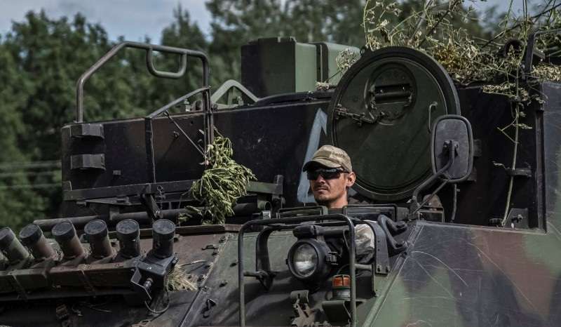 Ukrainian servicemen ride APC near the Russian border in Sumy region