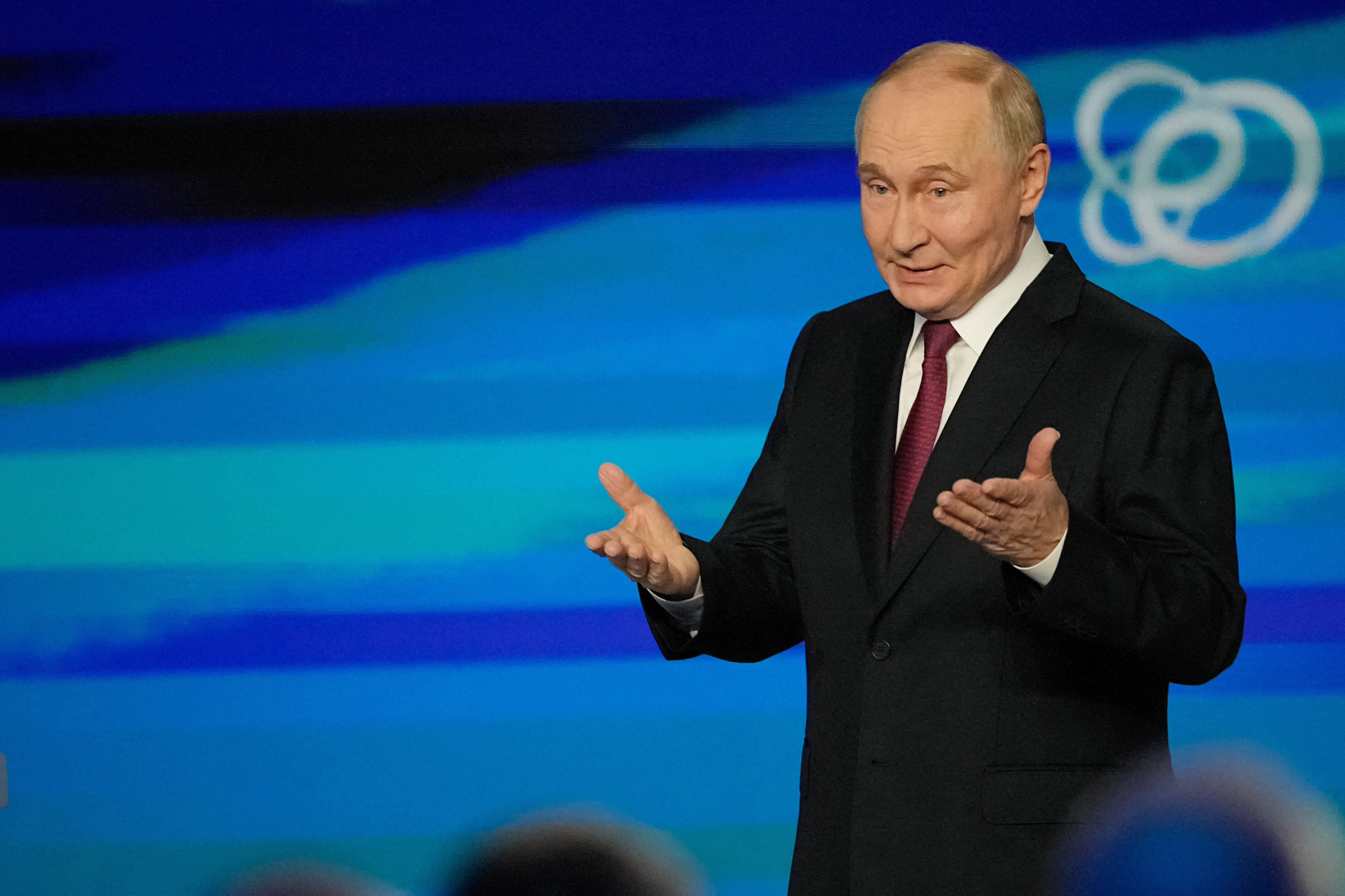 Russian President Vladimir Putin gestures during a plenary session of the Russian Energy Week forum at Moscow Manege in Moscow