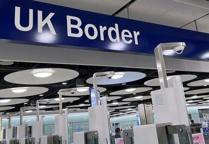 FILE PHOTO: A sign is seen at passport control area of Terminal 5, at Heathrow Airport, London