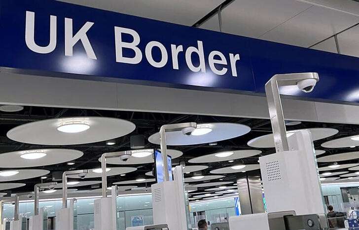 FILE PHOTO: A sign is seen at passport control area of Terminal 5, at Heathrow Airport, London