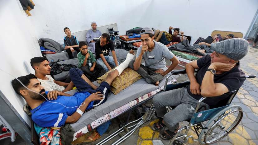 Palestinian man, who was wounded in Israeli fire, lies on a bed as he receives treatment at Al-Aqsa hospital in Deir Al-Balah in the central Gaza Strip