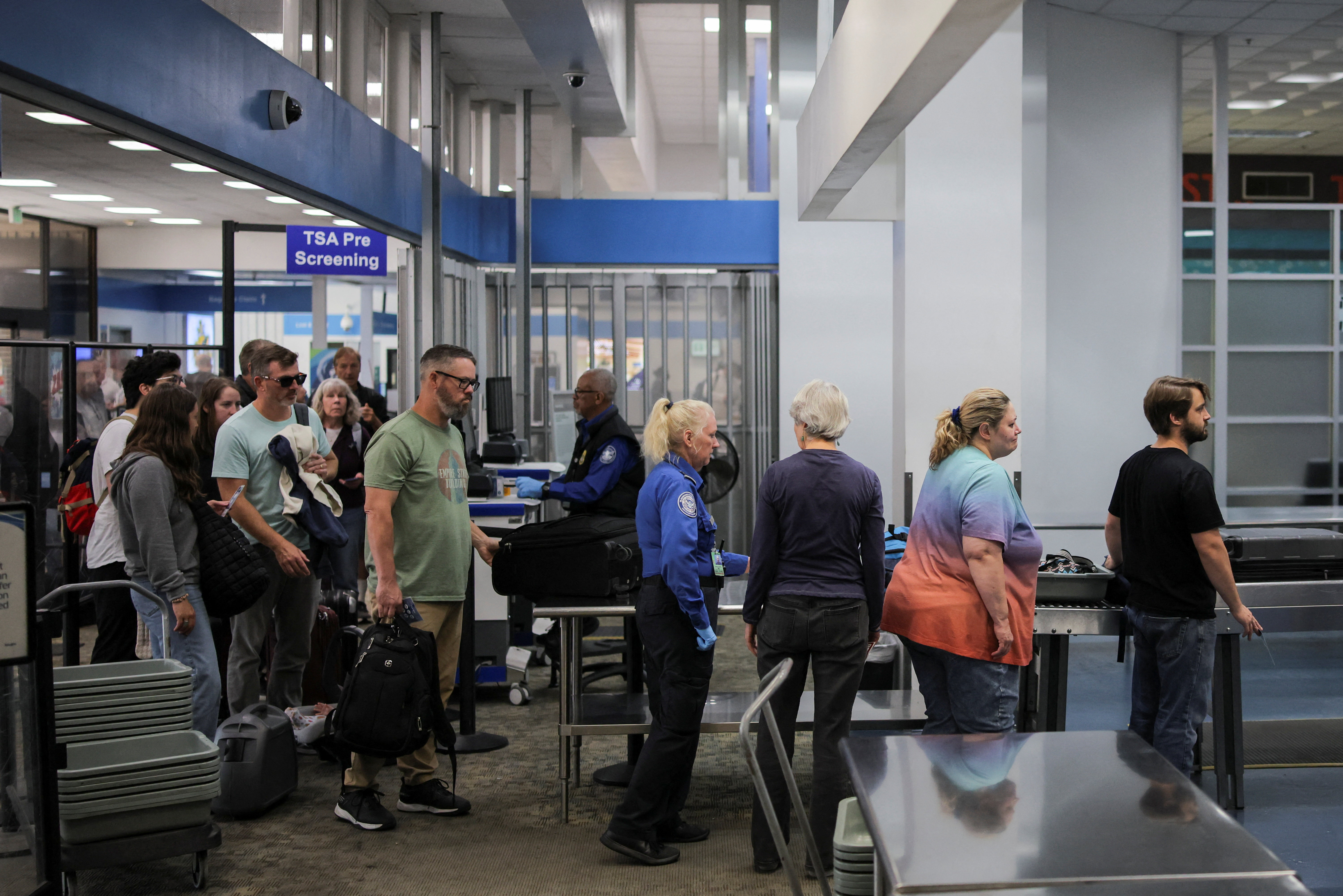 Transportation Security Administration (TSA) works during the first day of a partial U.S. government shutdown in Burbank