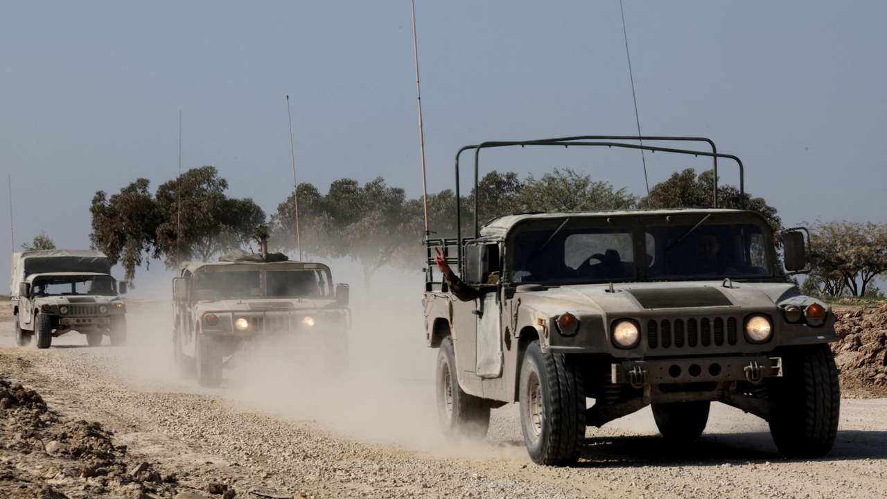 FILE PHOTO: Israeli military vehicles move near the Israel-Gaza border