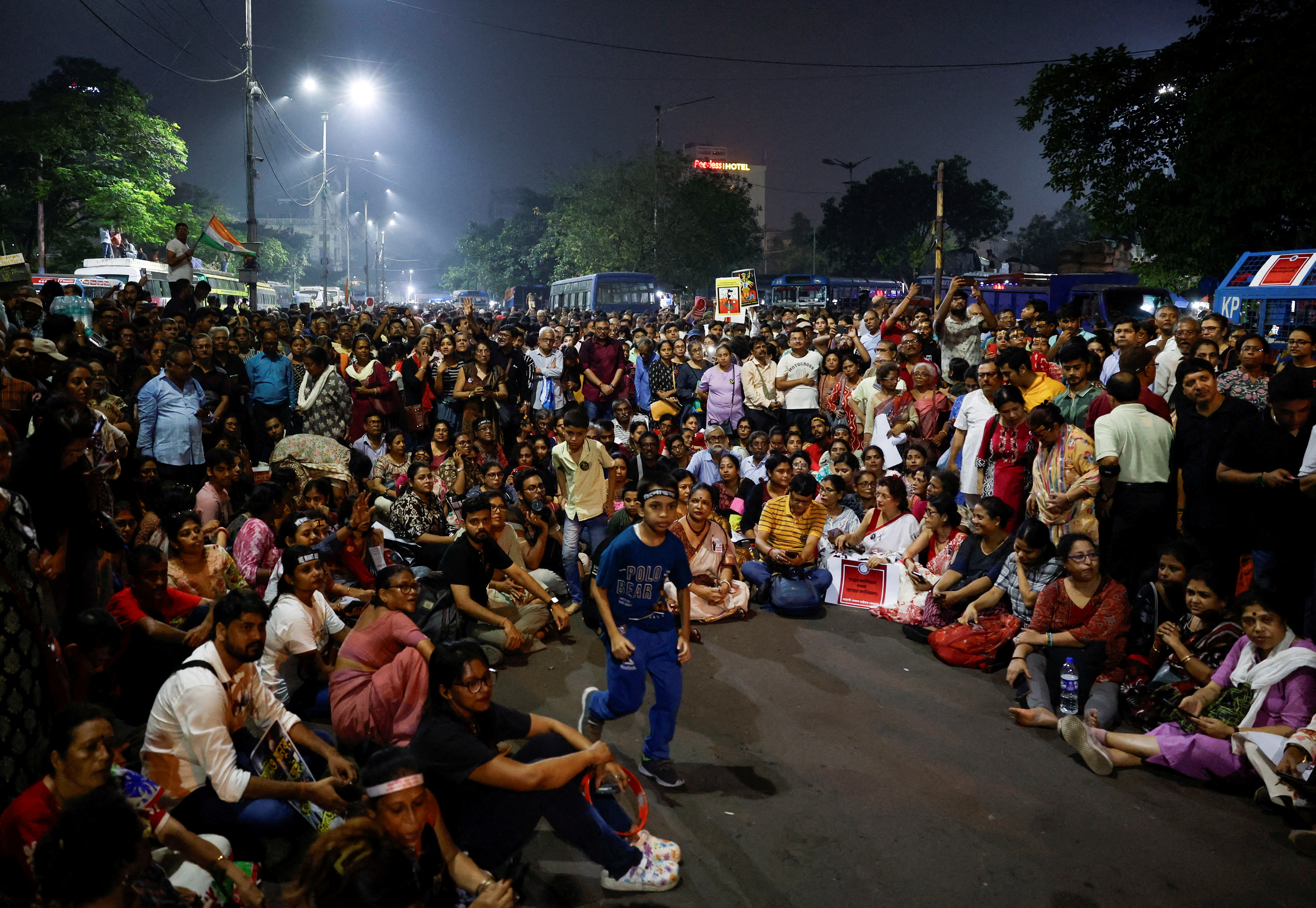 People take part in a protest condemning the rape and murder of a trainee medic at a government-run hospital, in Kolkata