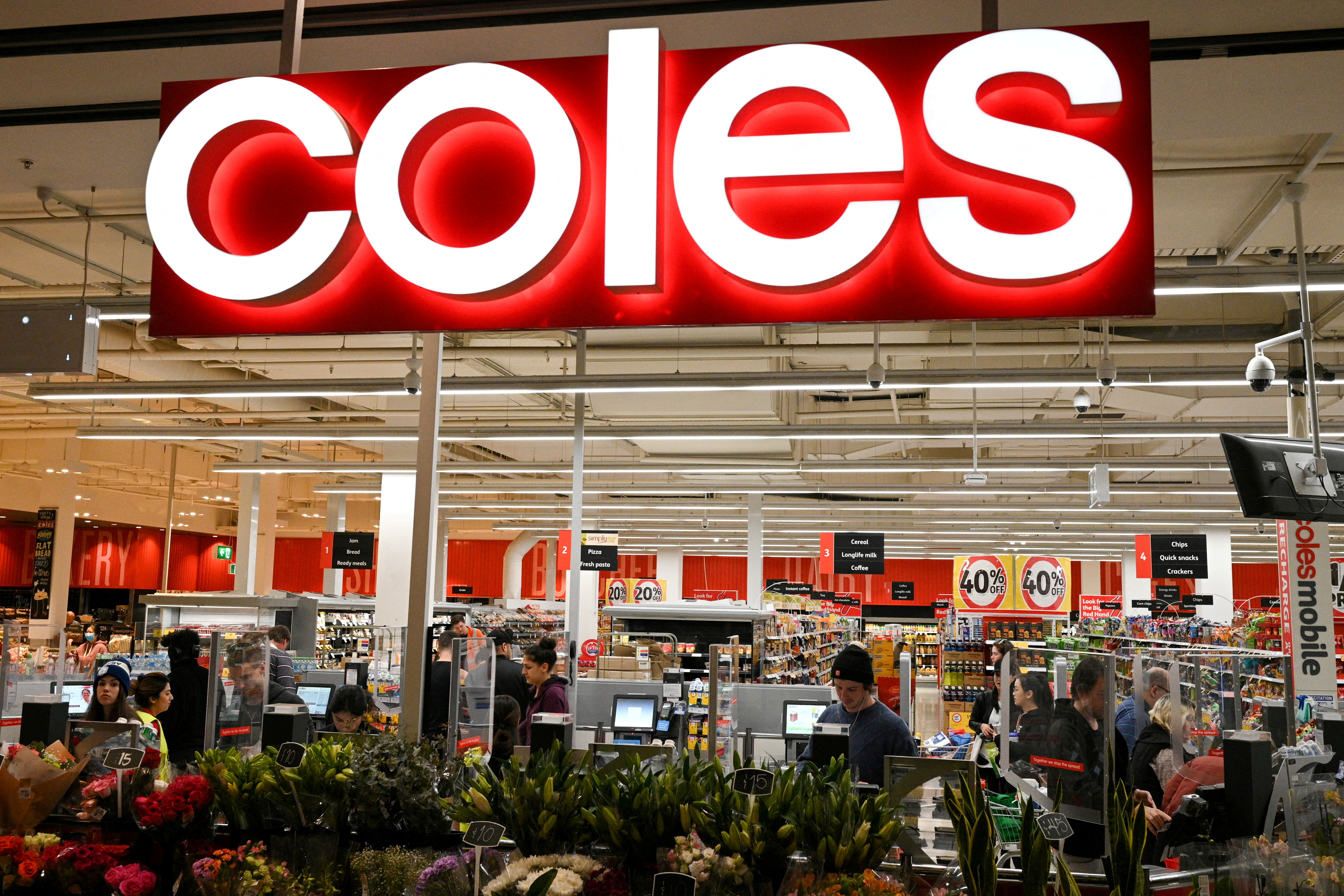 FILE PHOTO: FILE PHOTO: Customers seen in the self-service checkout area of a Coles supermarket in Sydney, Australia