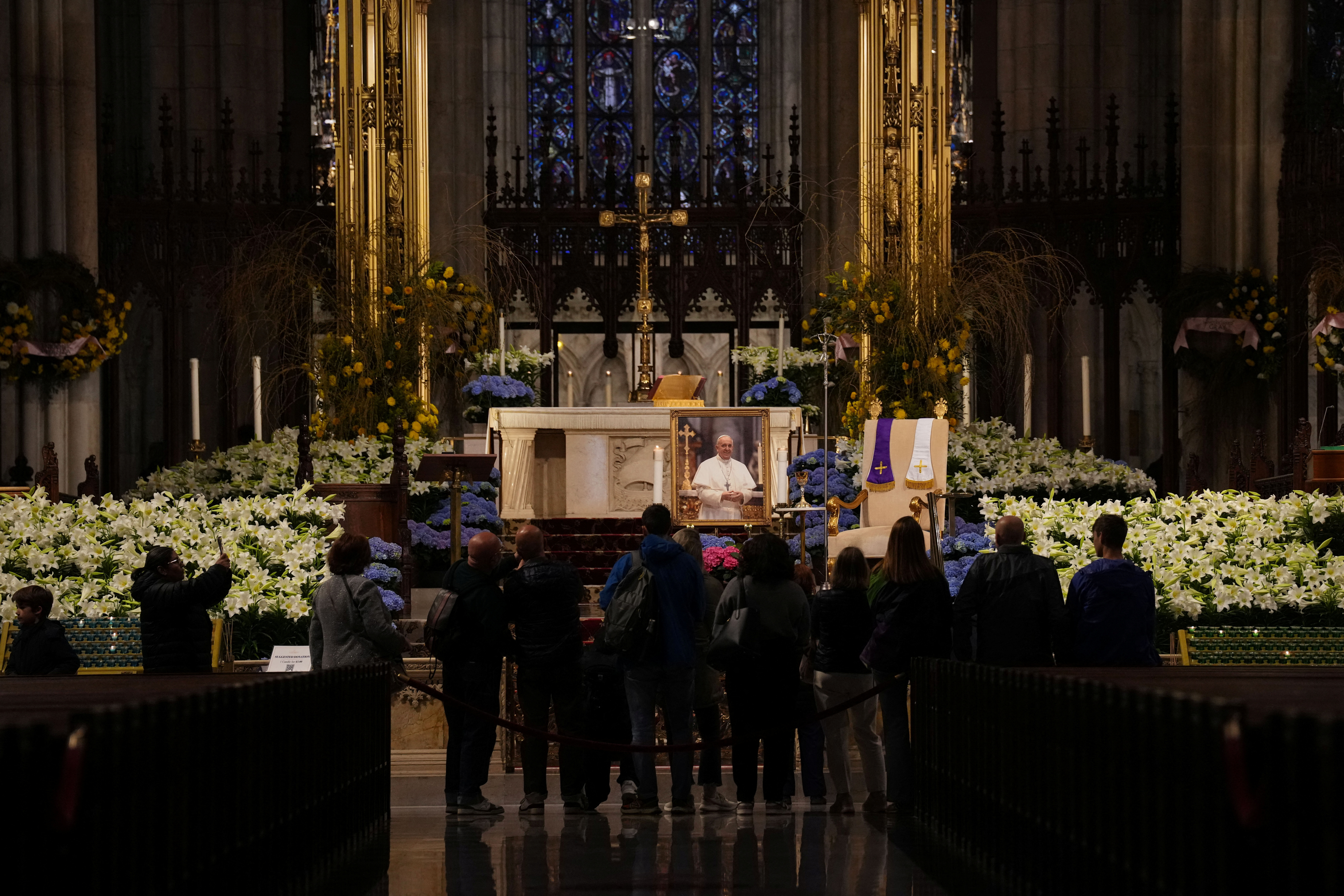 A photo of Pope Francis is kept on display as people pay their respects, after the death of Pope Francis was announced by the Vatican, at St Patrick's Cathedral in Manhattan