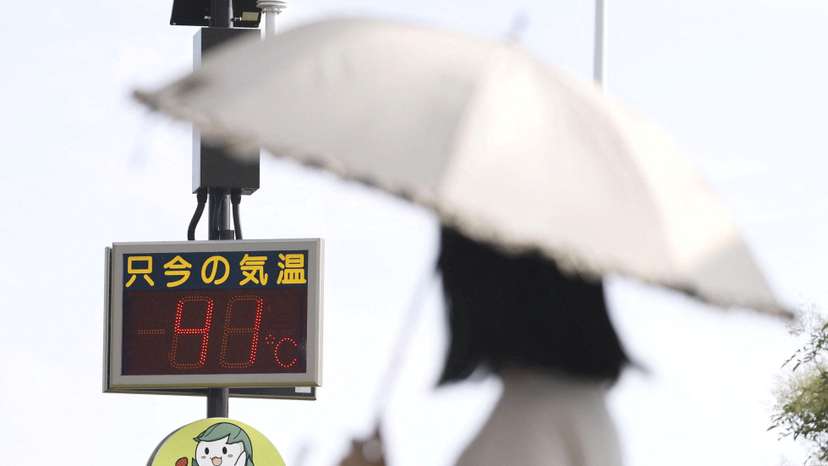 A digital thermometer display shows a temperature of 41 degree Celsius in front of JR Isesaki station in Isesaki
