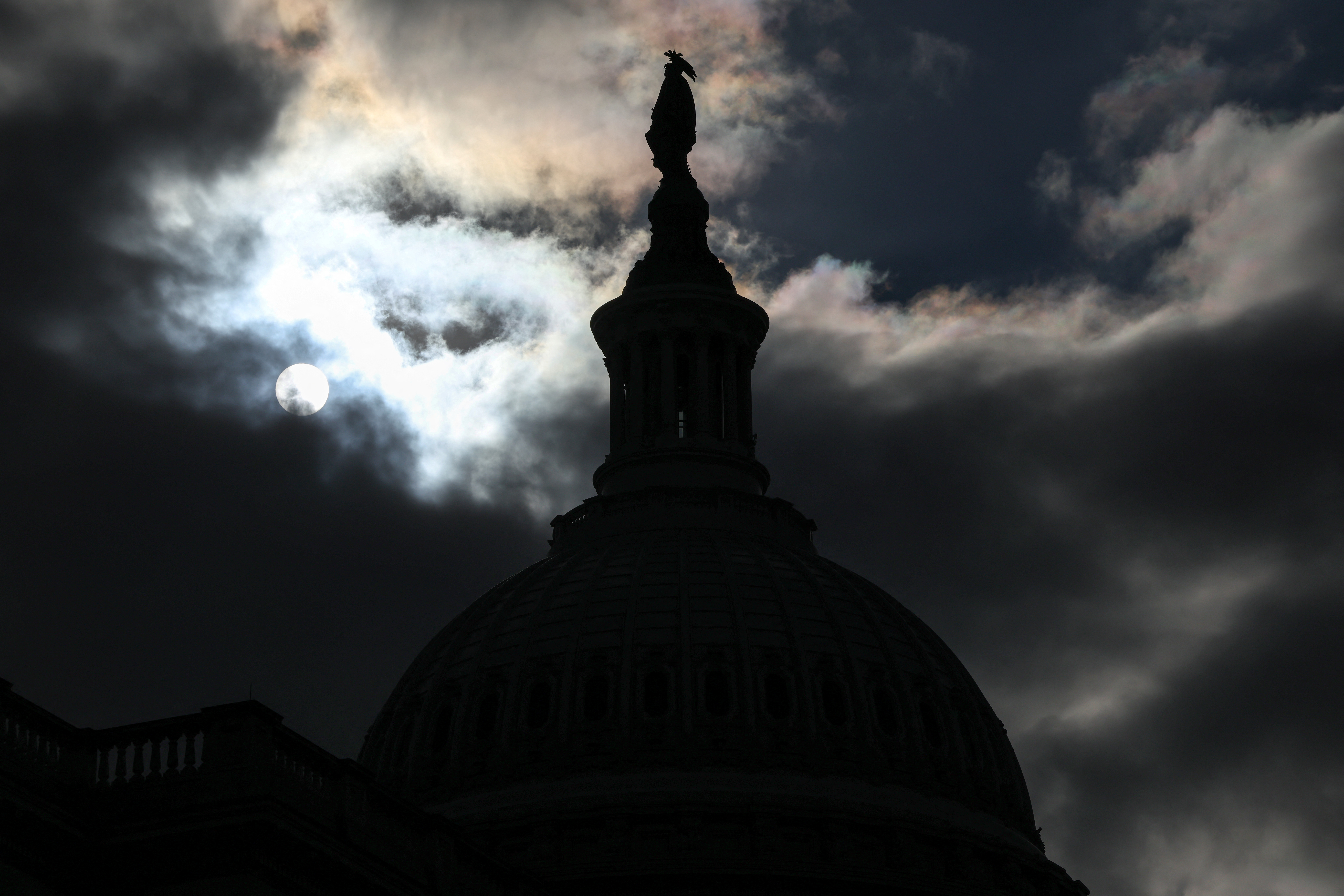 The US Capitol dome is silhouetted against the sun in Washington