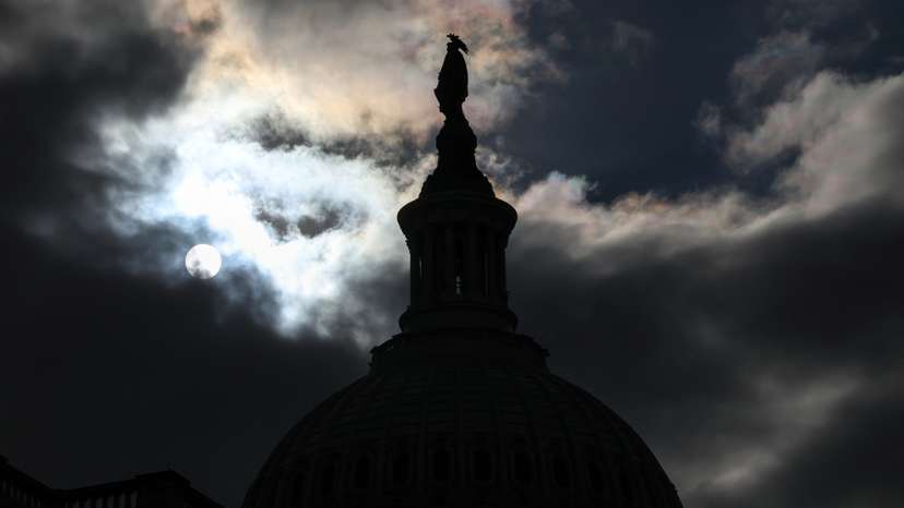The US Capitol dome is silhouetted against the sun in Washington