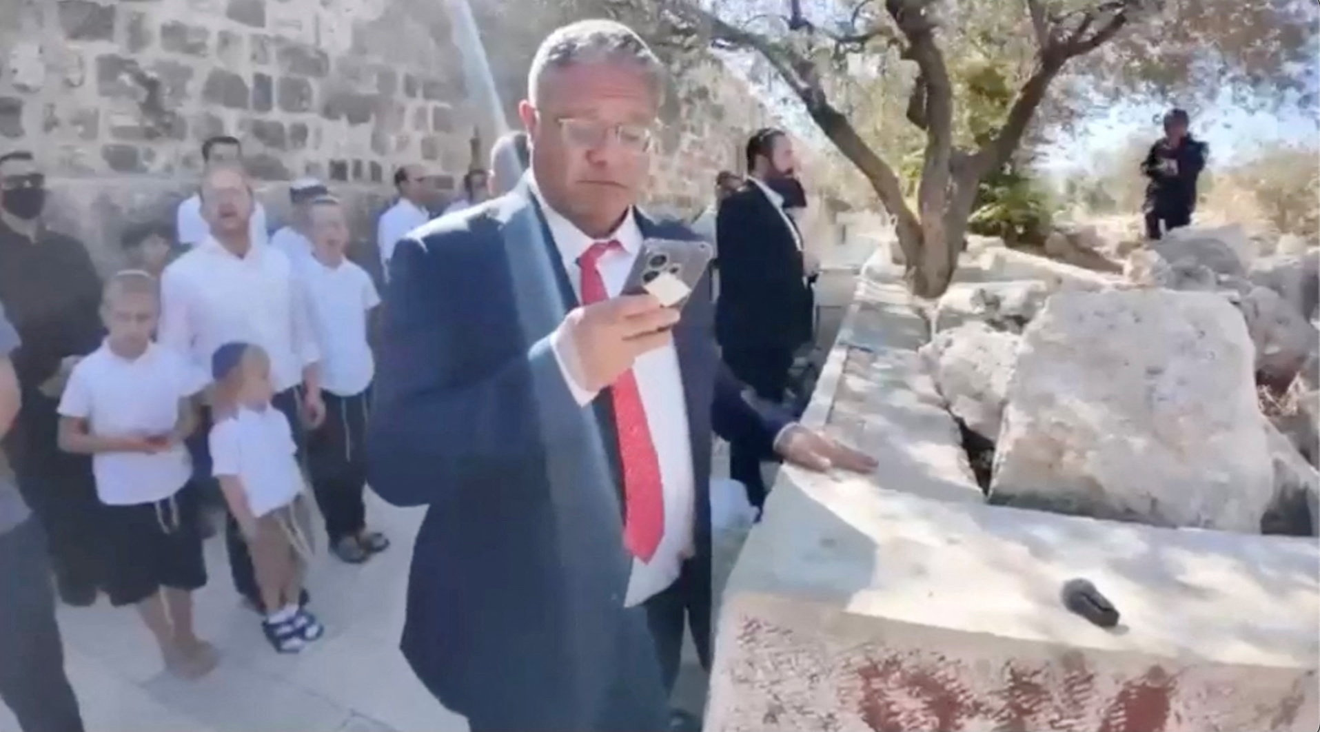 A screengrab from a video shows Israeli National Security Minister Itamar Ben-Gvir as he prays at the Al-Aqsa Mosque compound during the Jewish holiday of Sukkot