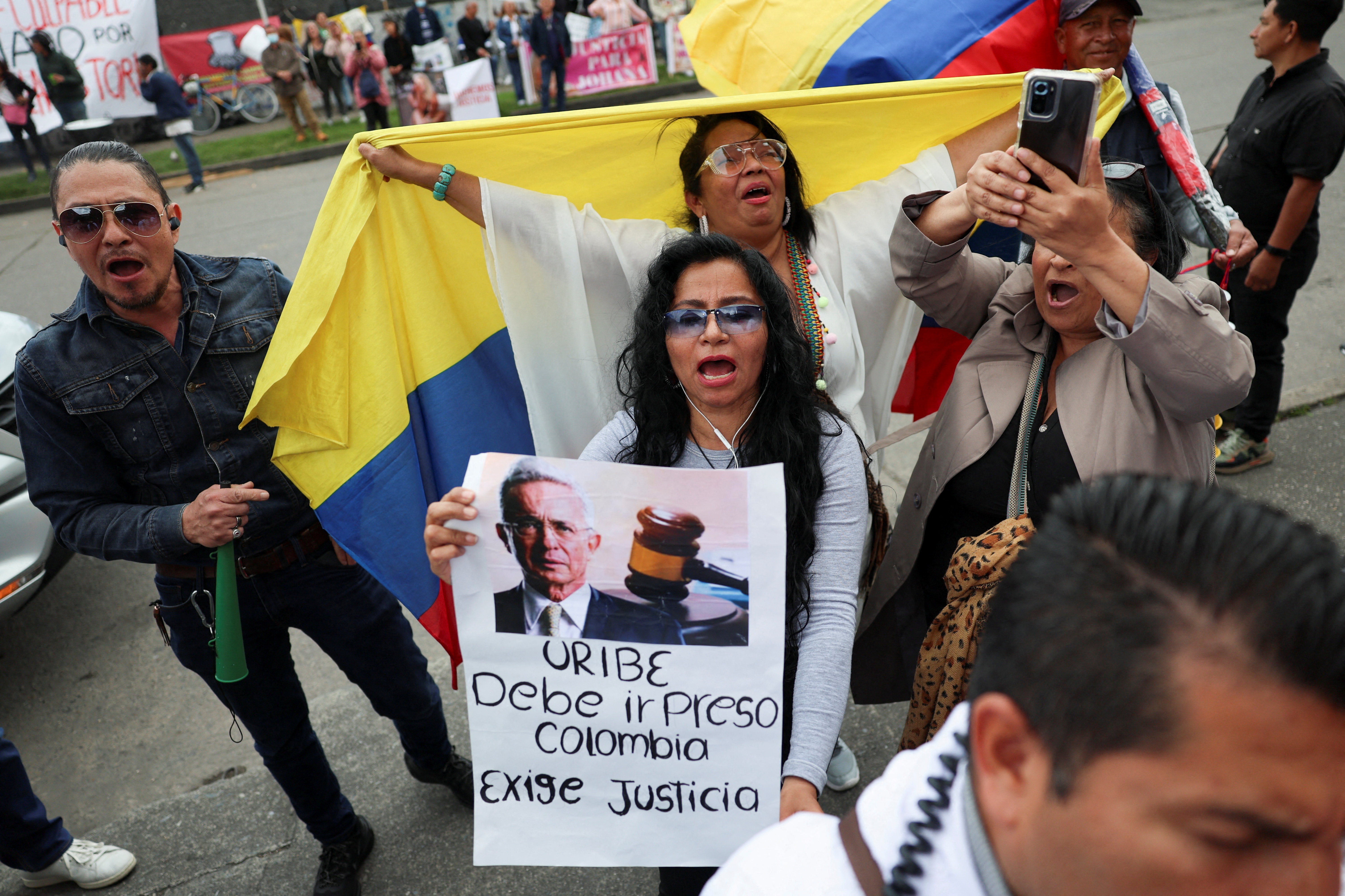 People protest against former Colombia's President Alvaro Uribe following his criminal conviction, outside the Paloquemao judicial complex