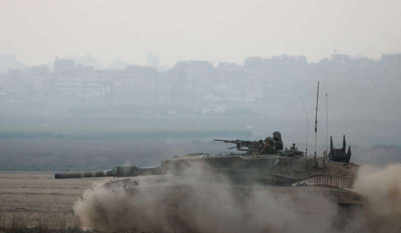 An Israeli tank manoeuvres, amid the Israel-Hamas conflict, near the Israel-Gaza border, in Israel