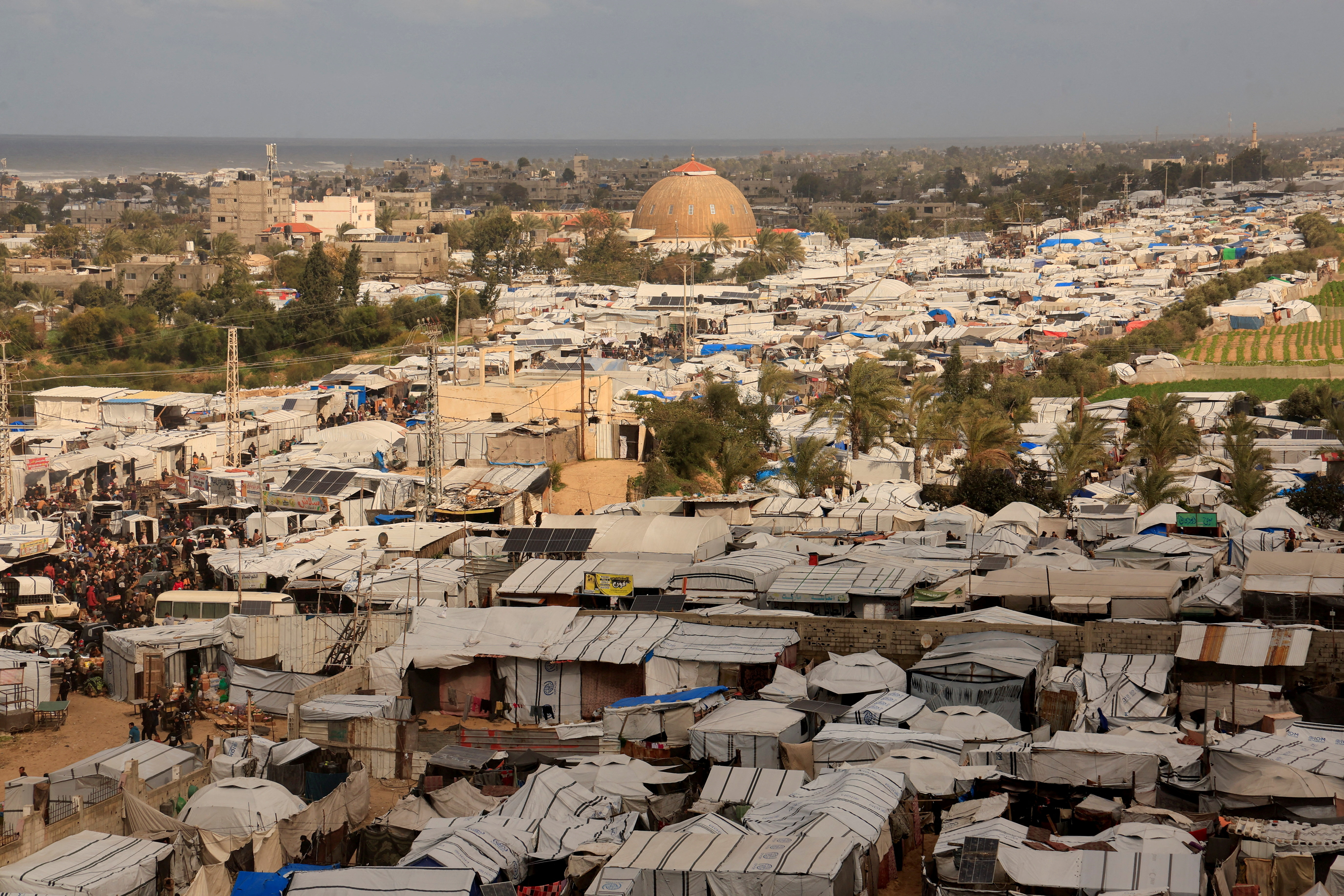 FILE PHOTO: Displaced Palestinians shelter at a tent camp in Khan Younis
