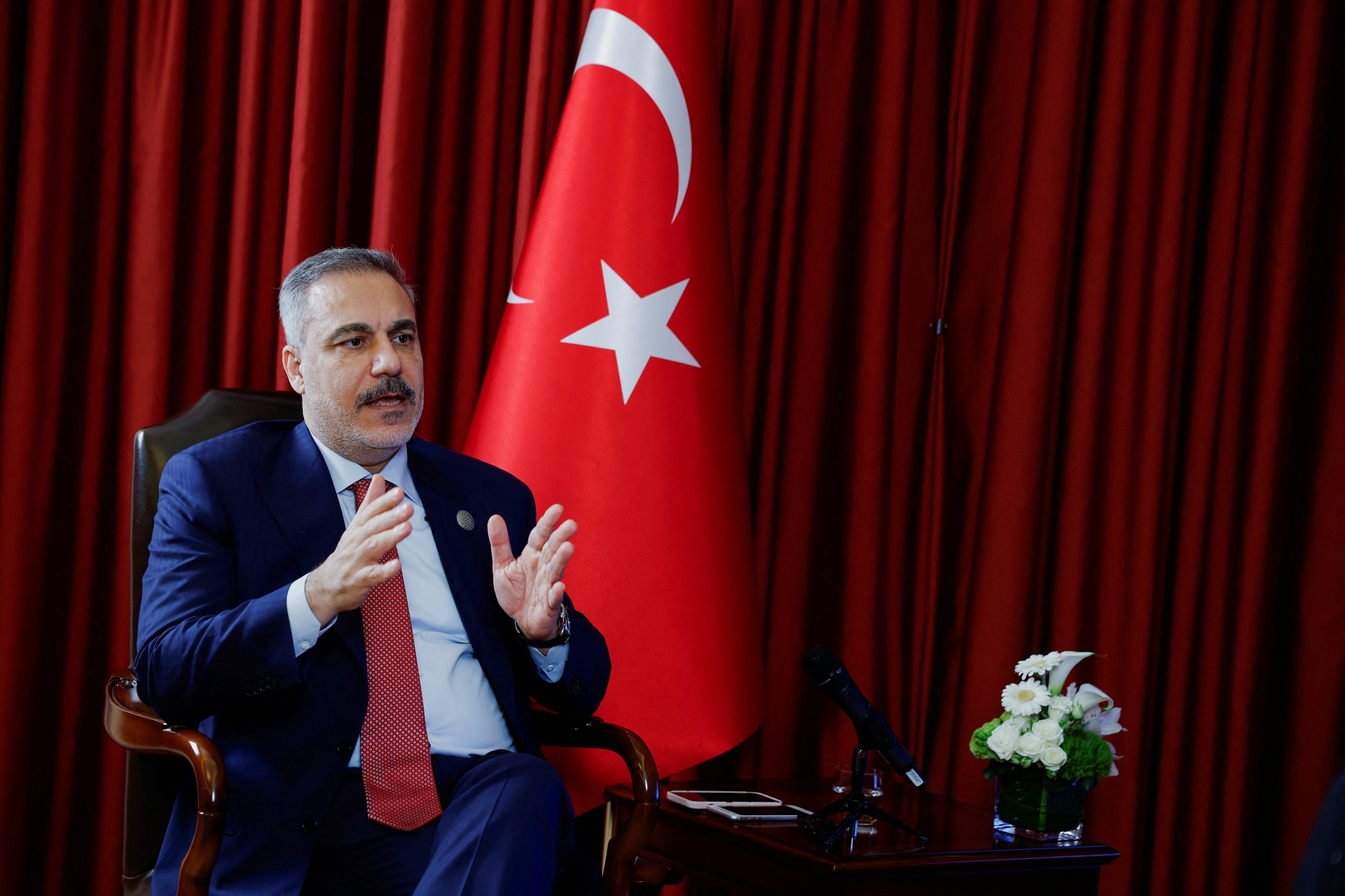 Turkish Foreign Minister Hakan Fidan speaks during an interview with Reuters at the 23rd edition of the annual Doha Forum, in Doha