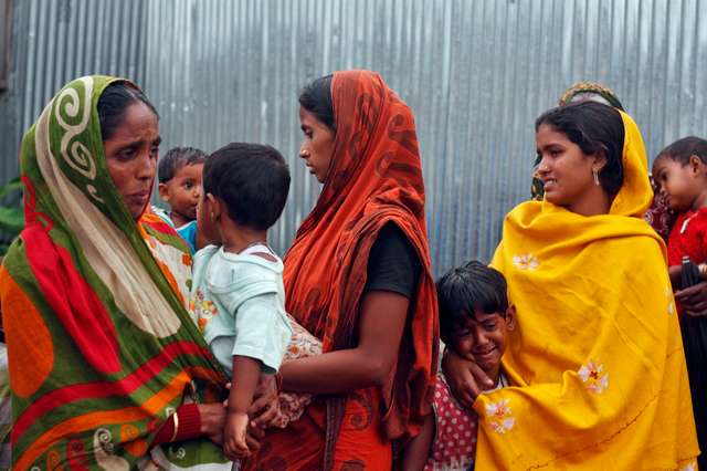 Villagers from Muslim communities affected by ethnic violence weep at a relief camp in Narayanguri village in Baksa