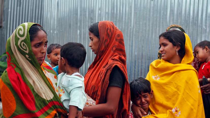 Villagers from Muslim communities affected by ethnic violence weep at a relief camp in Narayanguri village in Baksa