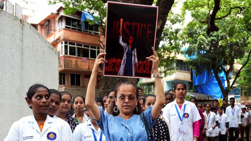 Doctors and residents hold posters and shout slogans during a protest condemning the rape and murder of a trainee medic at a government-run hospital in Kolkata, at a ground in Mumbai