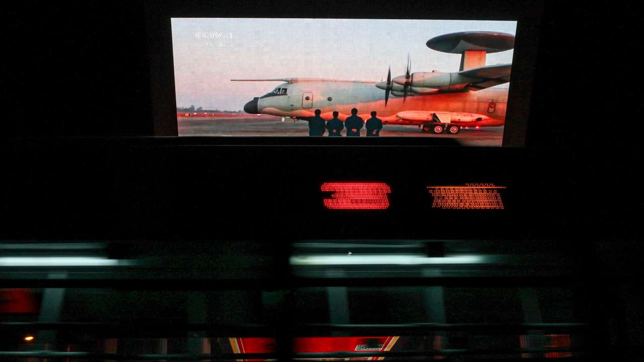 Screen showing a news report on China's military drills around Taiwan, in Beijing