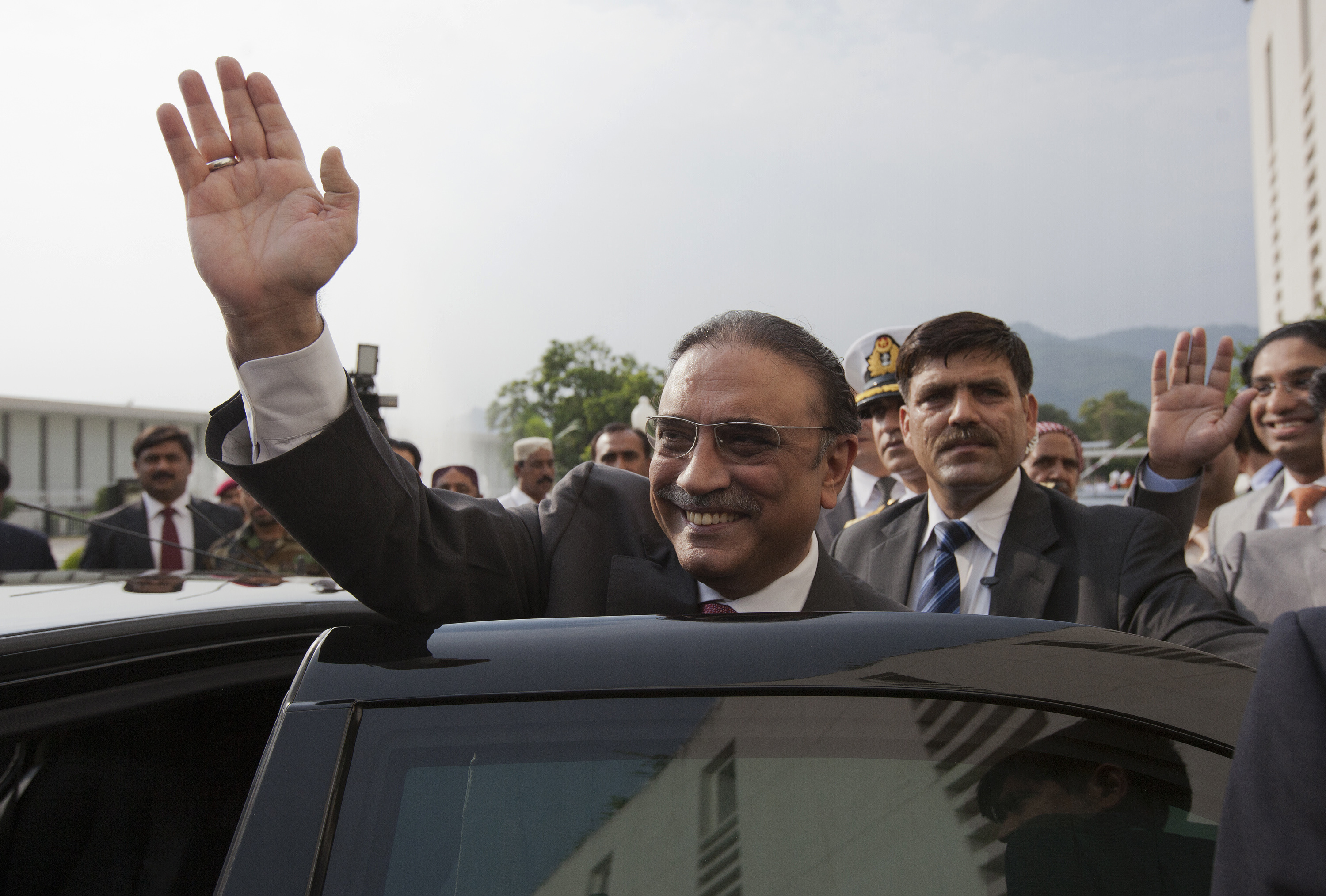 FILE PHOTO: Pakistan's outgoing President Zardari waves as he leaves after a farewell ceremony at the President House in Islamabad