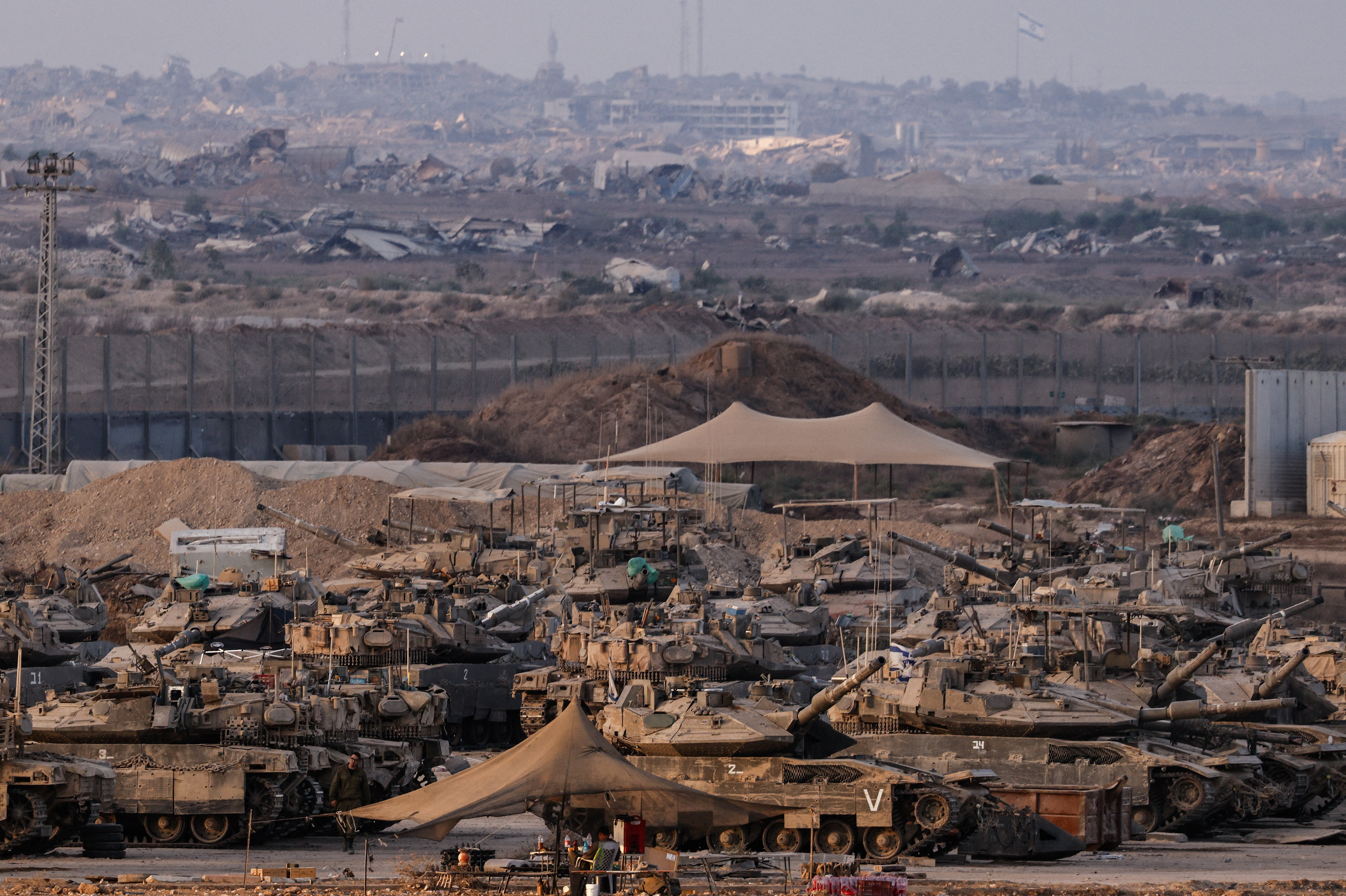 Israeli tanks stand on the Israeli side of the border with Gaza, in Israel