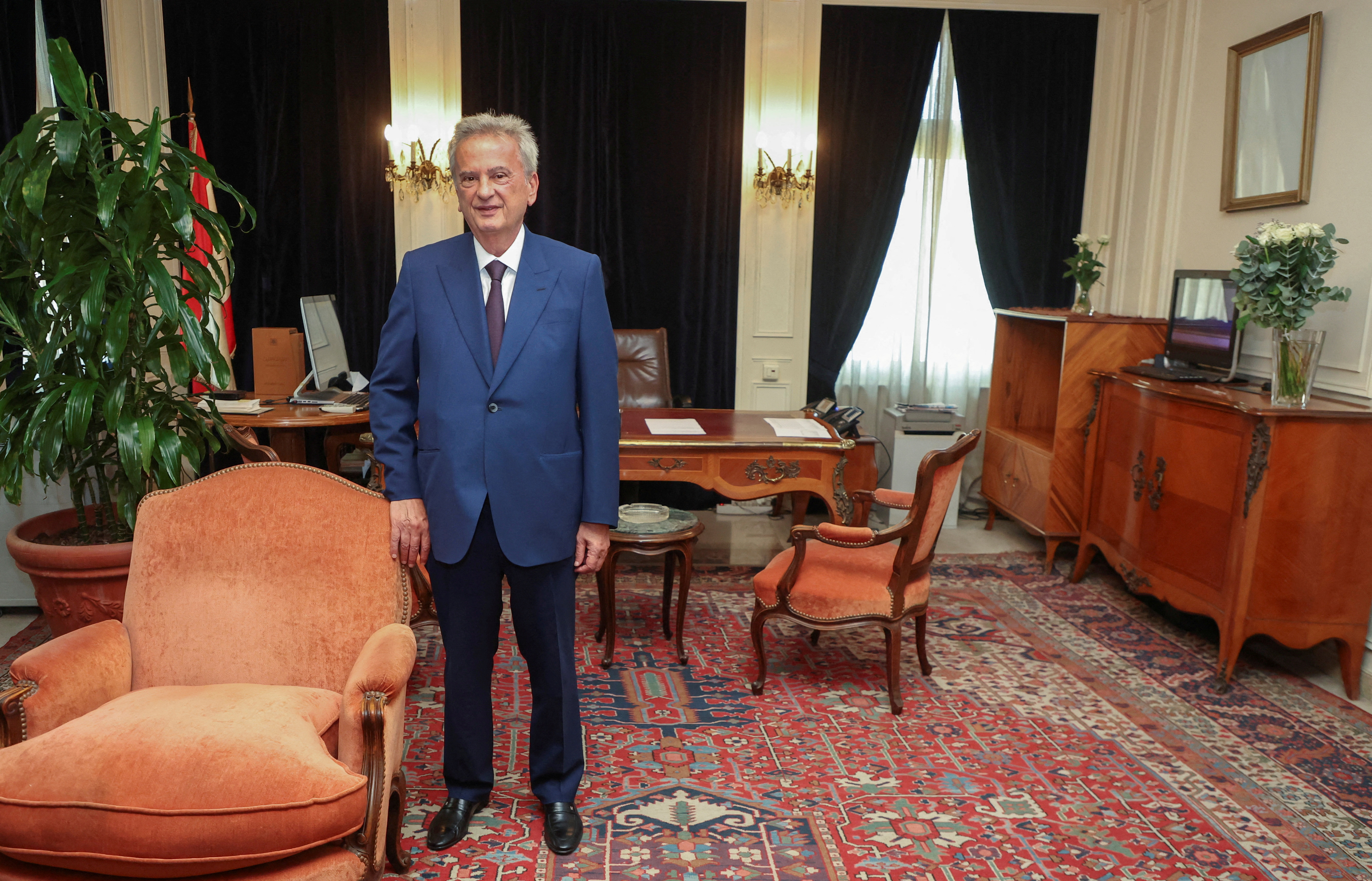 FILE PHOTO: Longtime chief of Lebanon's Central Bank Riad Salameh, poses as he leaves office after a 30-year tenure, at Lebanon's Central Bank building in Beirut